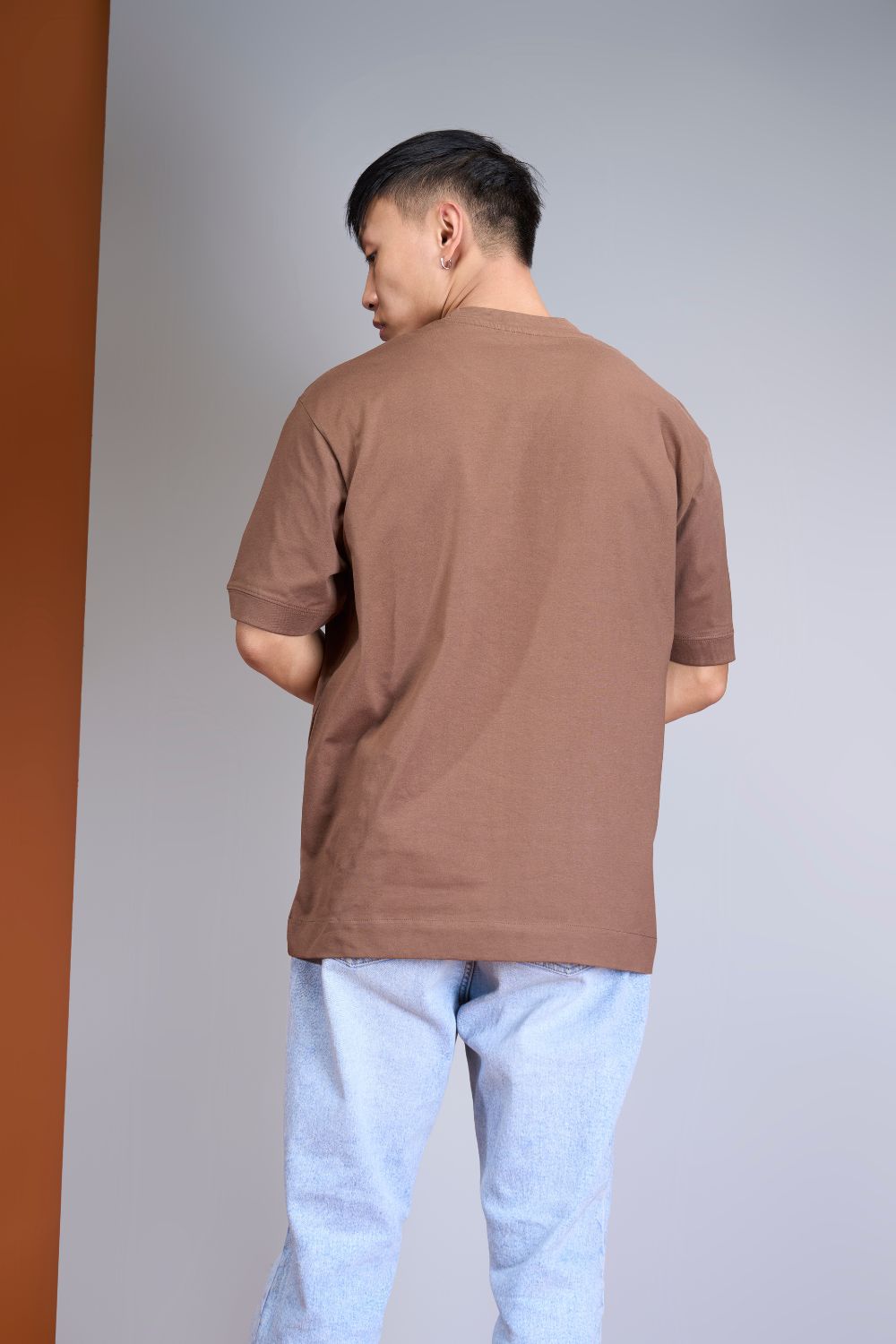 Light pink colored, Solid T shirt for men, with half sleeves and round neck, back view.