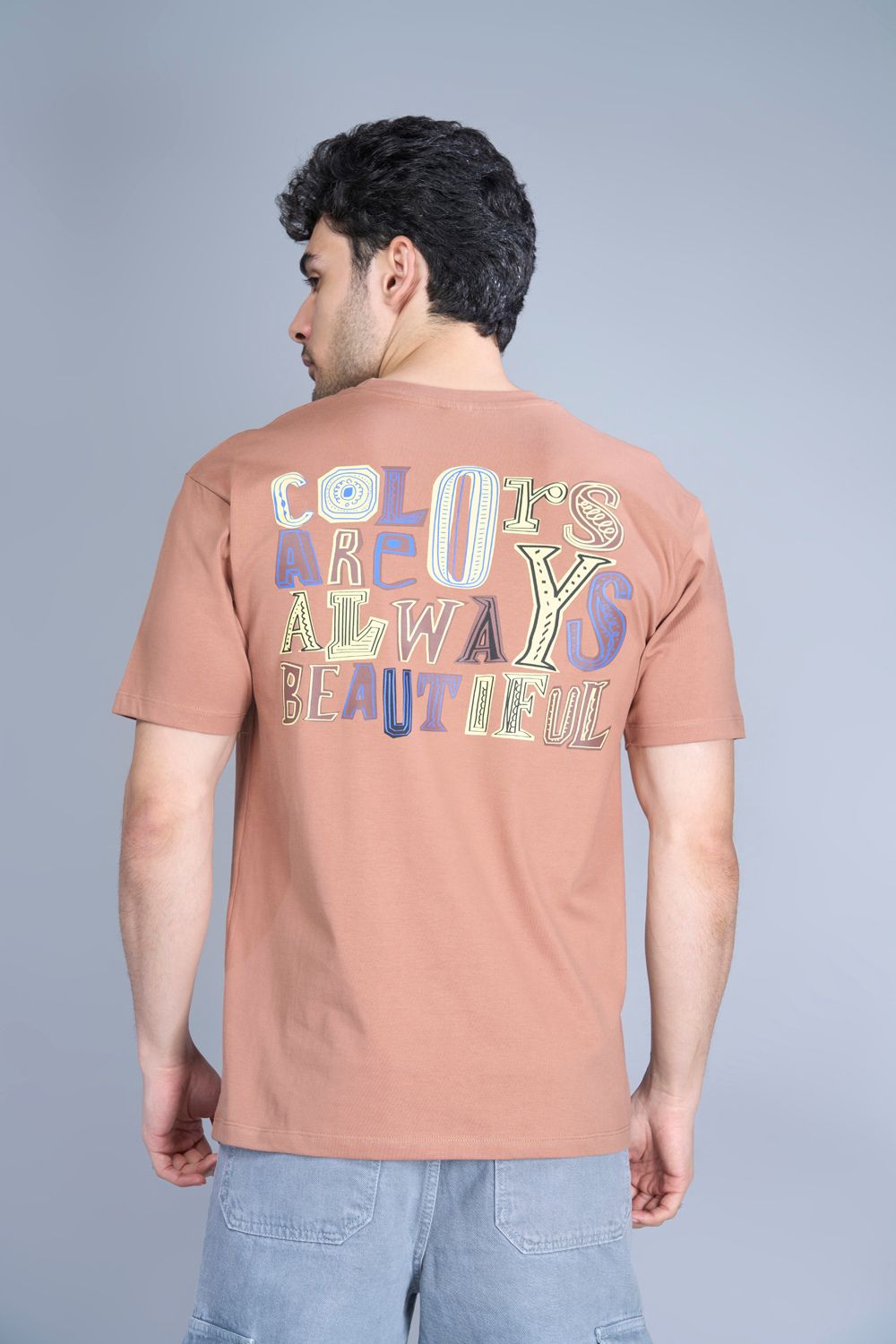 Cotton oversized T shirt for men in the solid color Café cream with half sleeves and crew neck, back view.