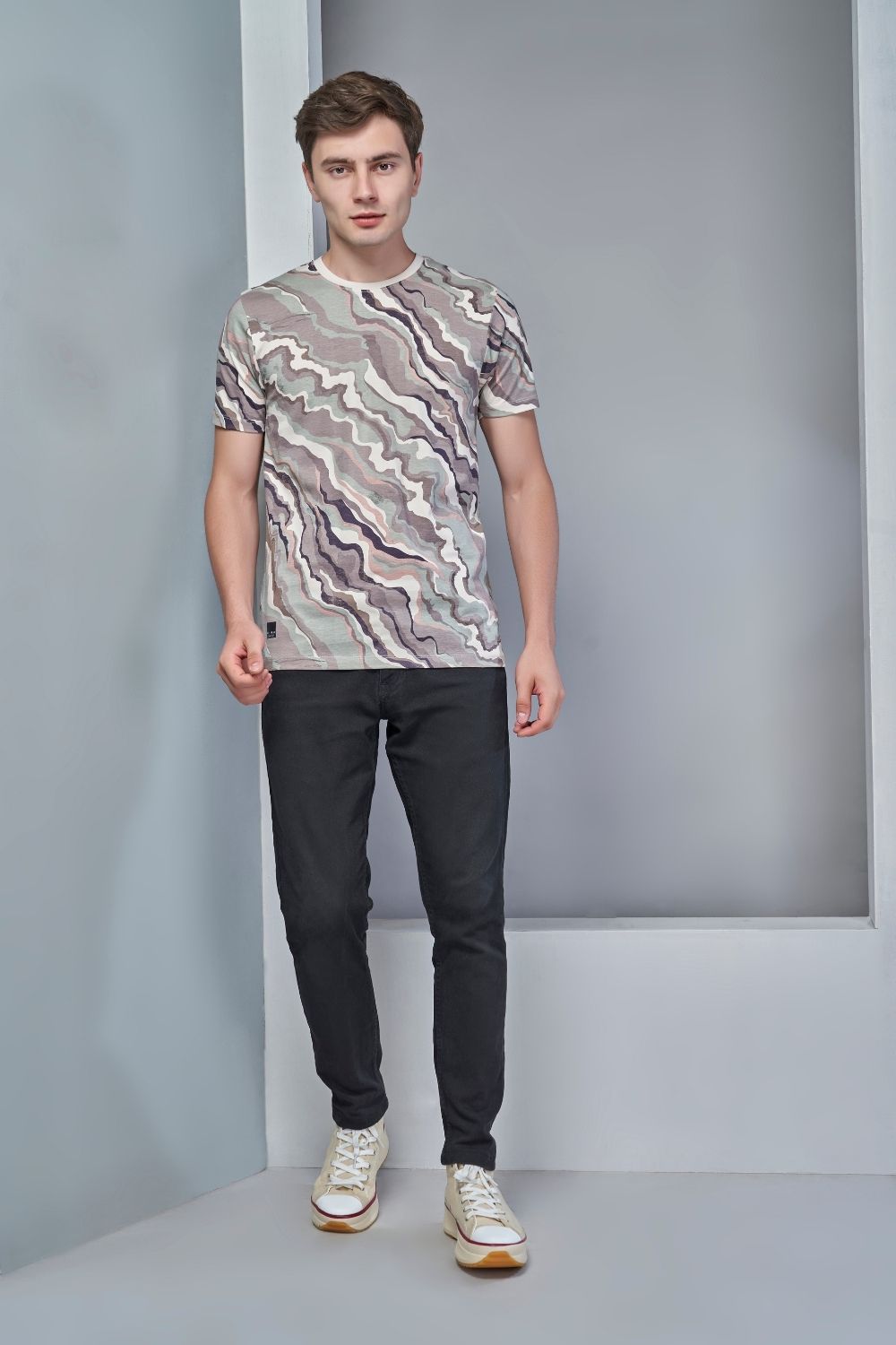 Beige colored, all over print T shirt for men with short sleeves and round neck, full view.