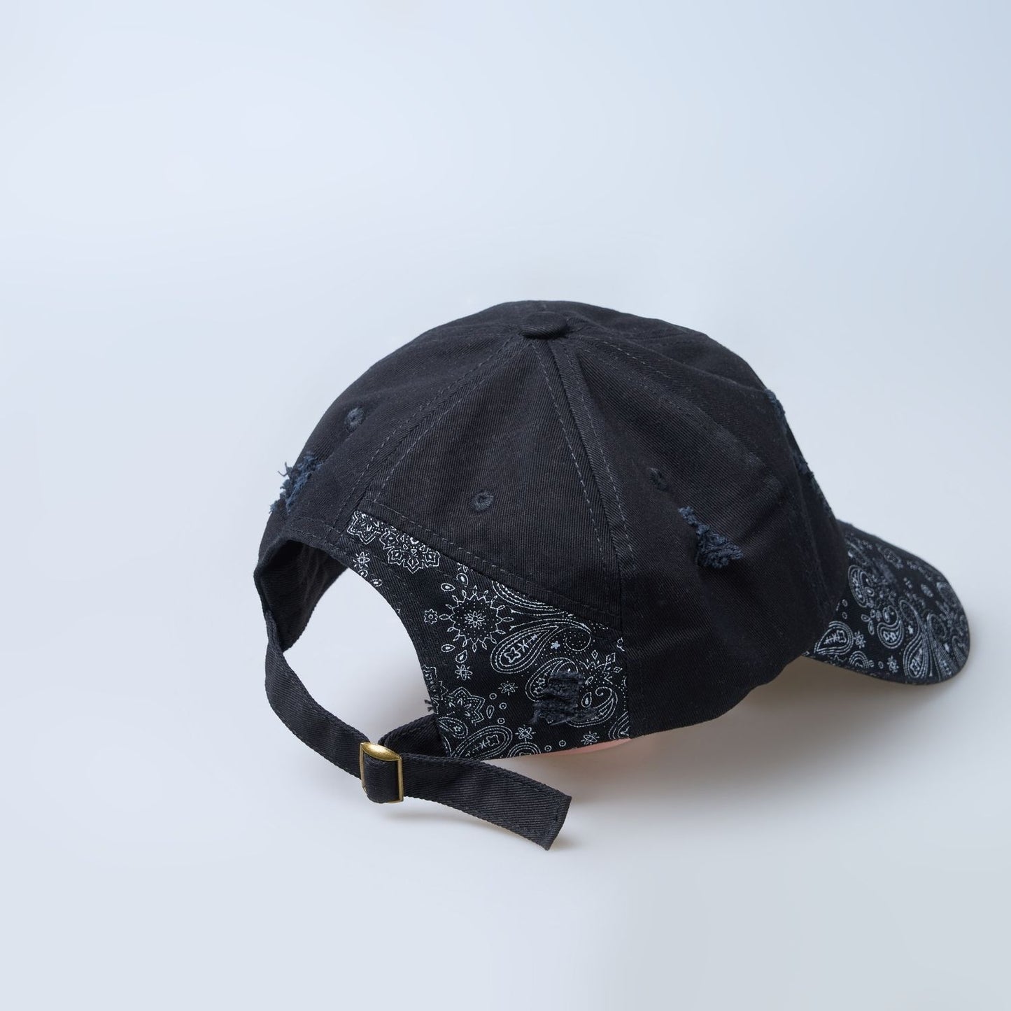 Black colored design patterned cap for men, back view.