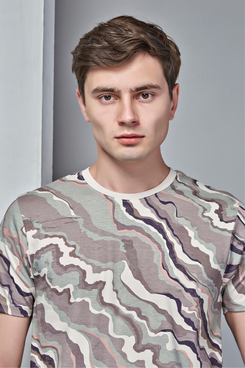 Beige colored, all over print T shirt for men with short sleeves and round neck, front view.