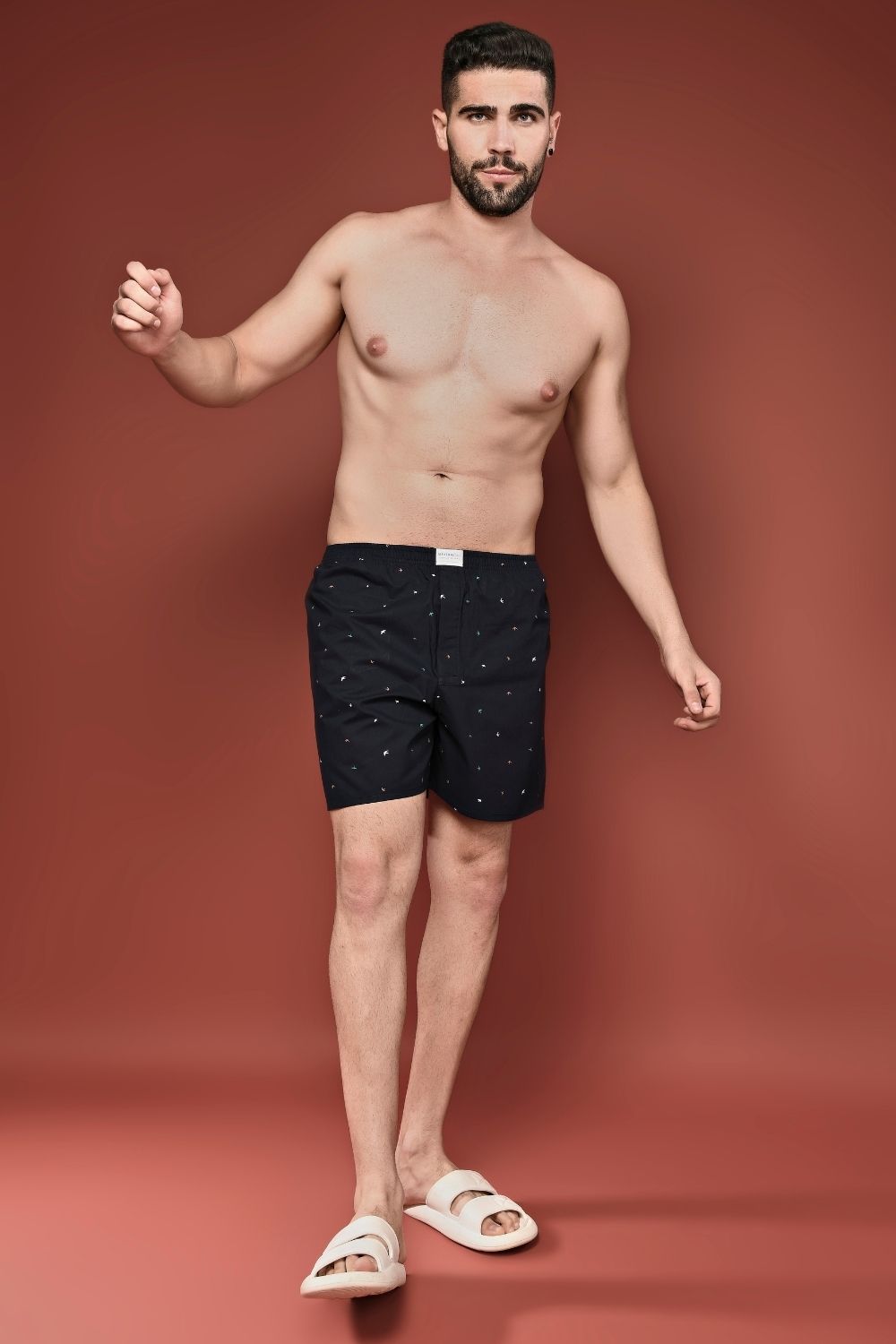 Design details of Teal Navy colored all over printed cotton boxer for men with back pockets.
