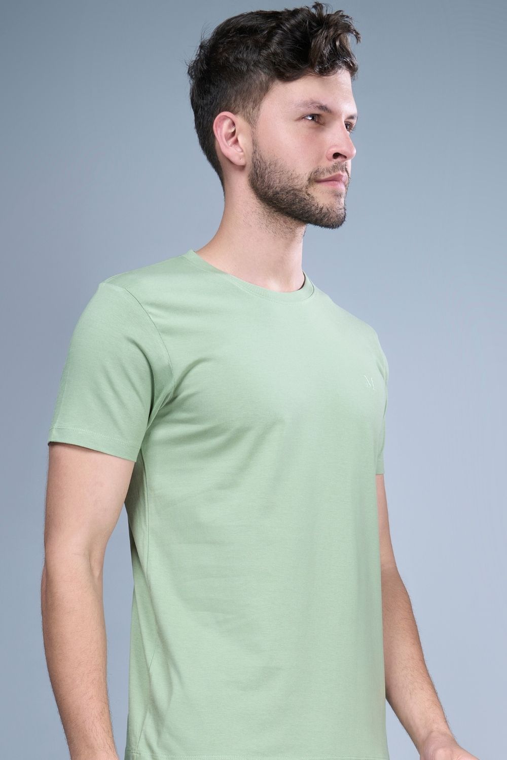Green colored, cotton Graphic T shirt for men with half sleeves and round neck, side view.