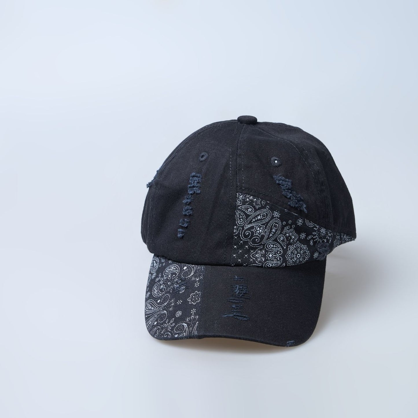 Black colored design patterned cap for men, front design detail.