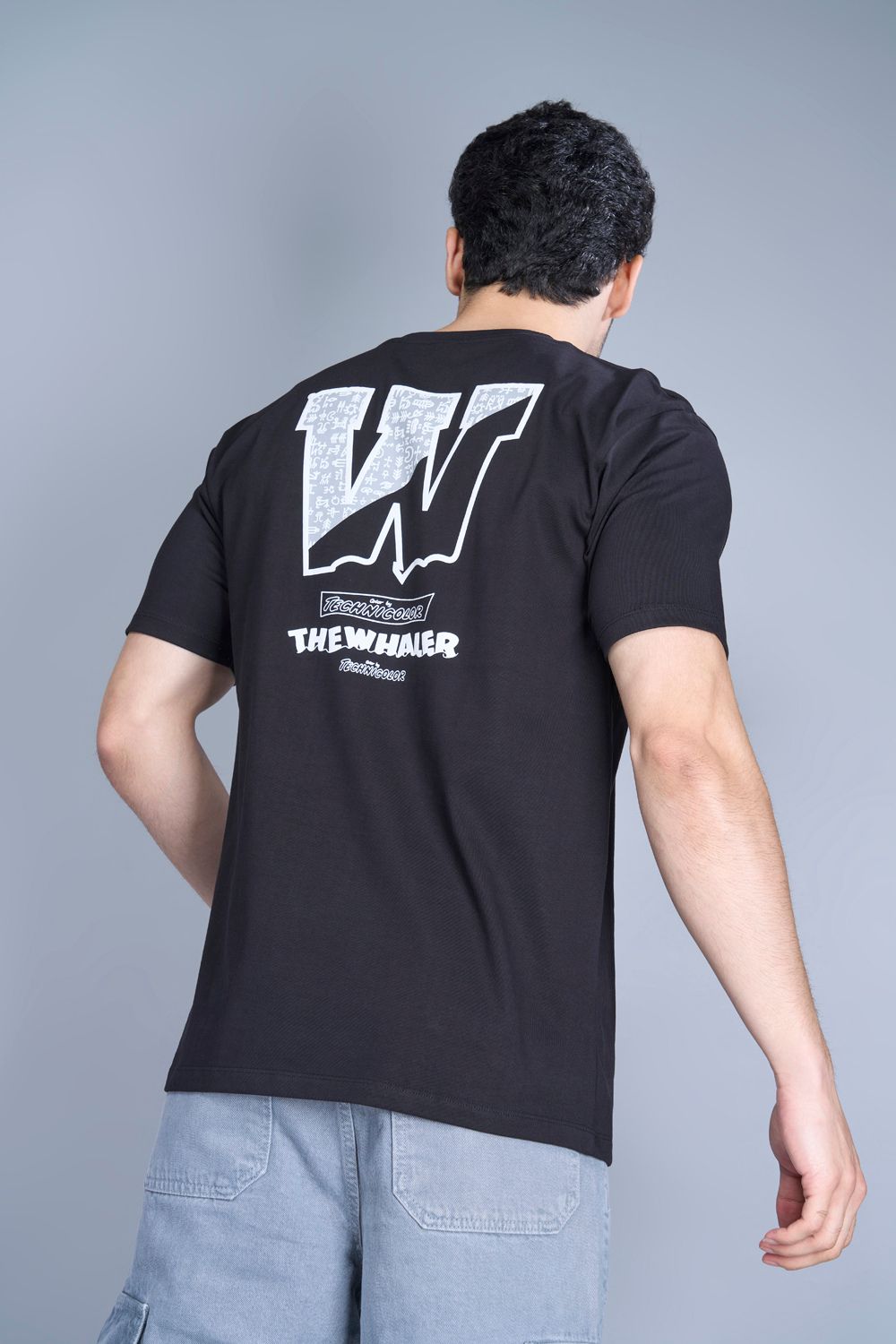 Cotton oversized T shirt for men in the solid color black with half sleeves and crew neck, back view.
