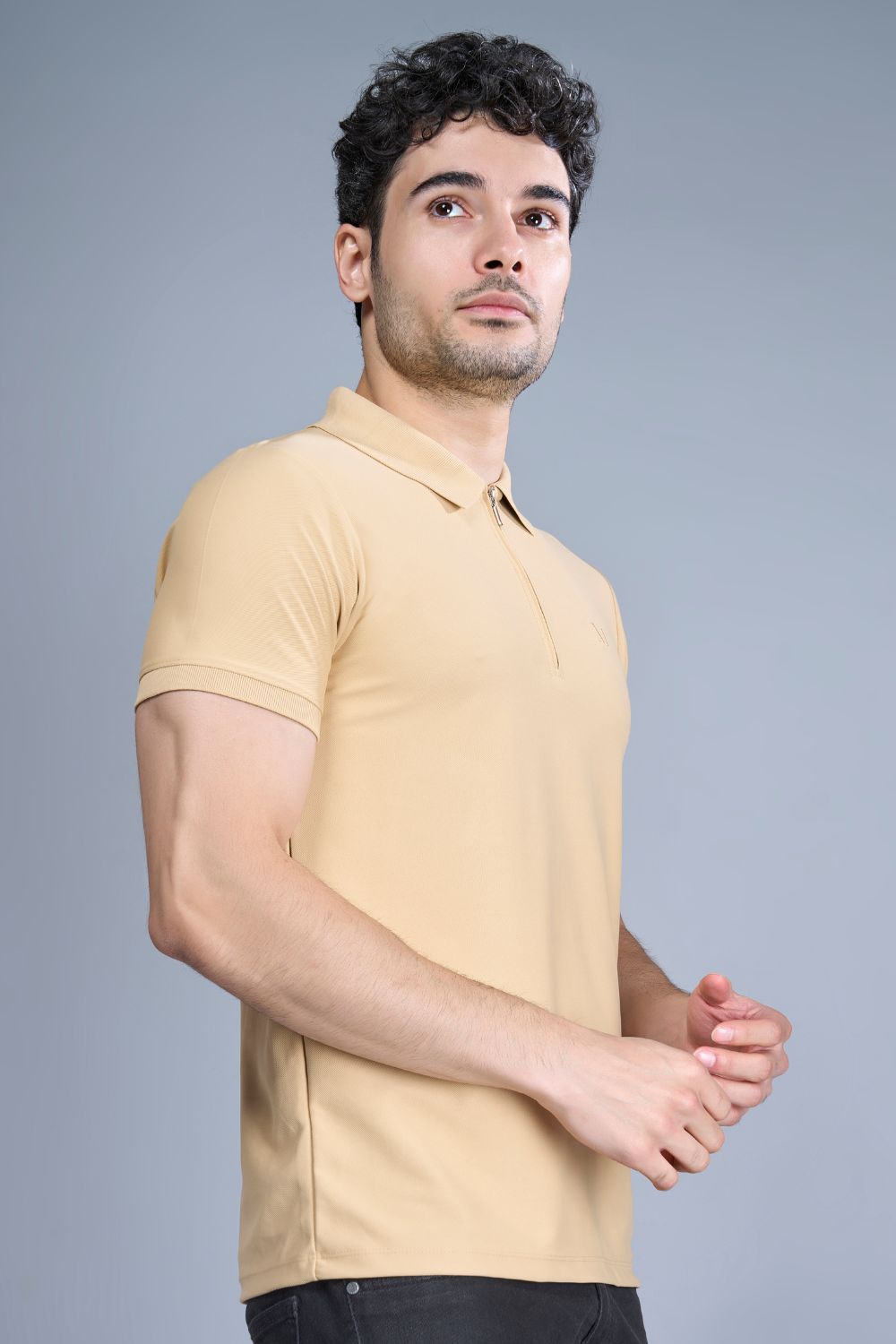 Bisque colored, zipped Polo T-shirts for men with collar and half sleeves, side view.
