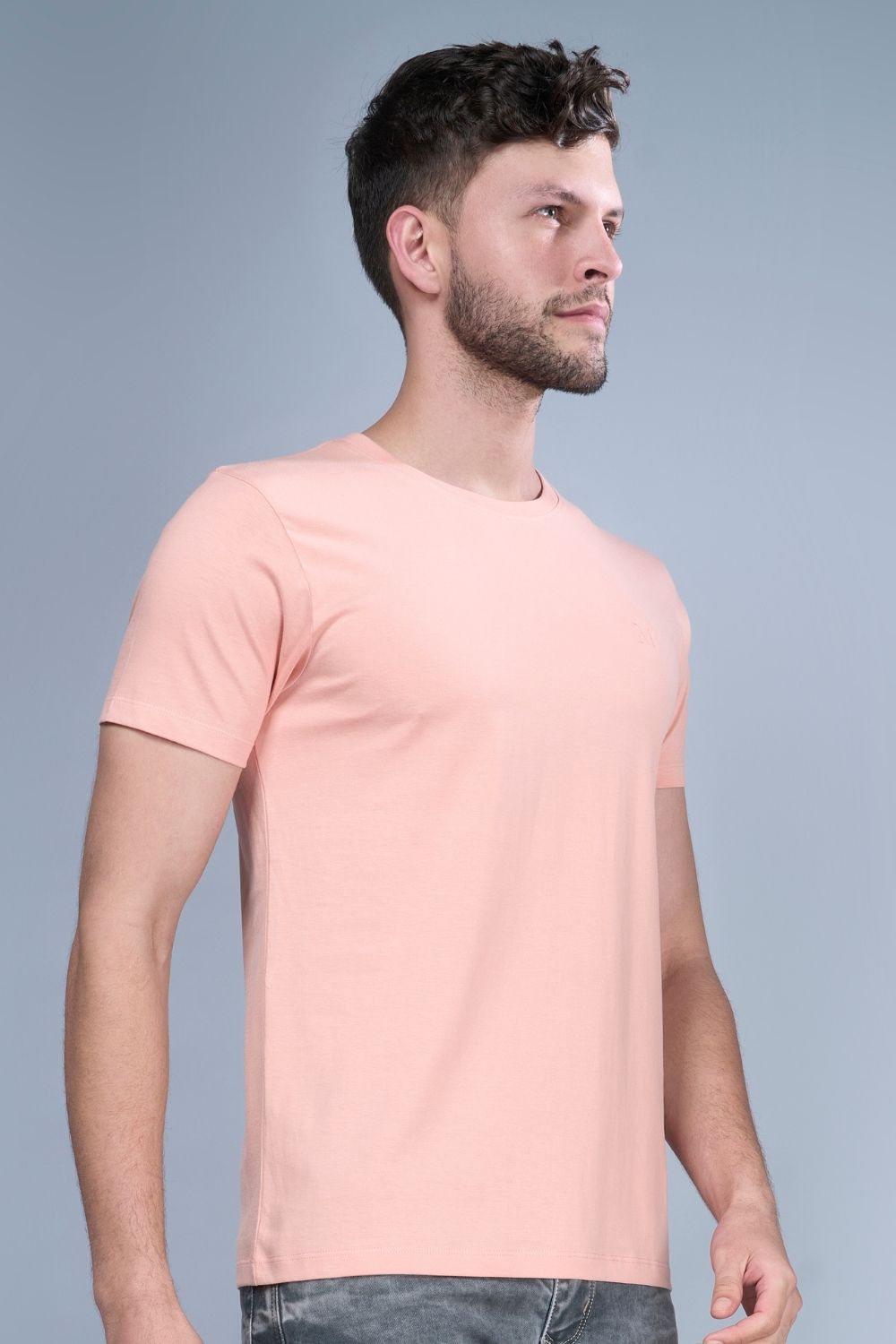 Light orange colored, Solid T shirt for men, with half sleeves and round neck, side view.