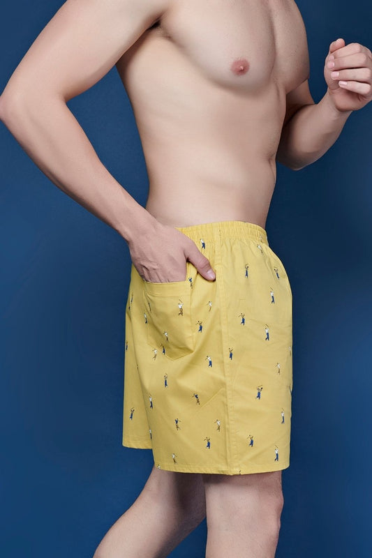 Yellow colored all over printed cotton boxer for men with back pockets, close up of pockets.