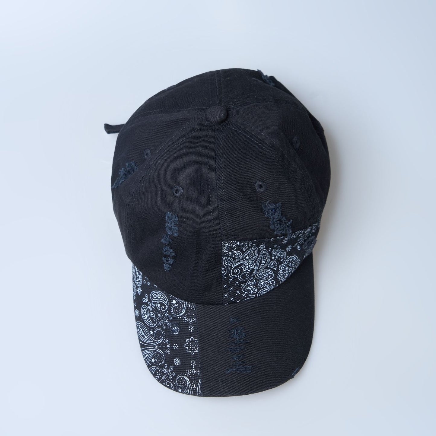 Up view of Black colored, design patterned cap for men.