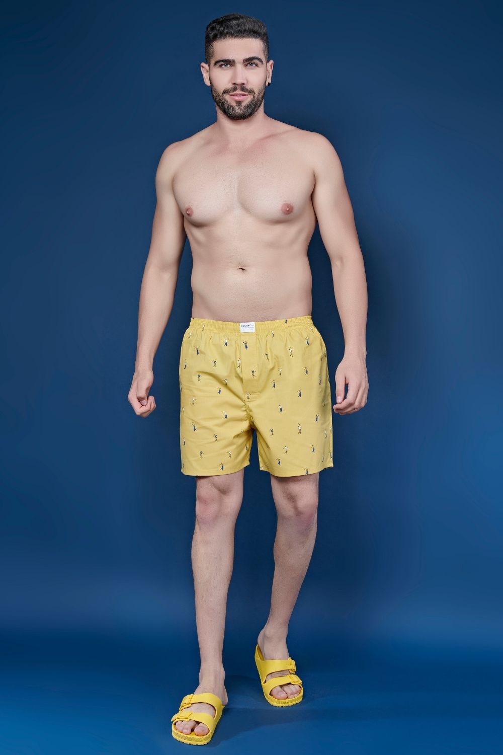 Yellow colored all over printed cotton boxer for men with back pockets, front.