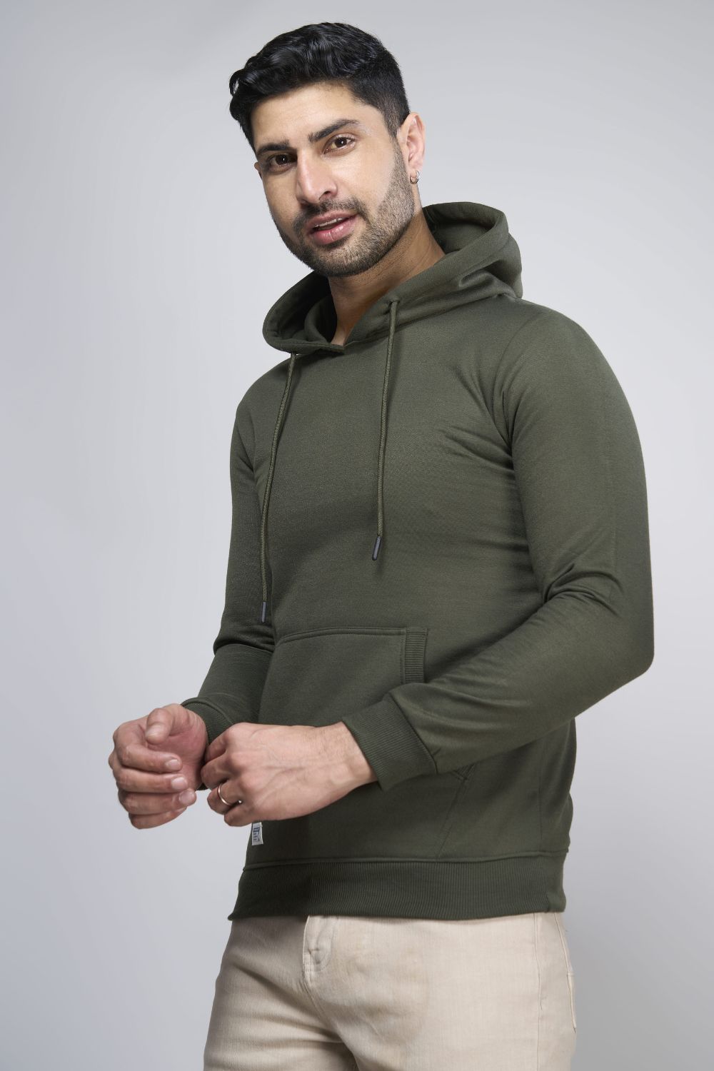 Olive colored, hoodie for men with full sleeves and relaxed fit, side view.