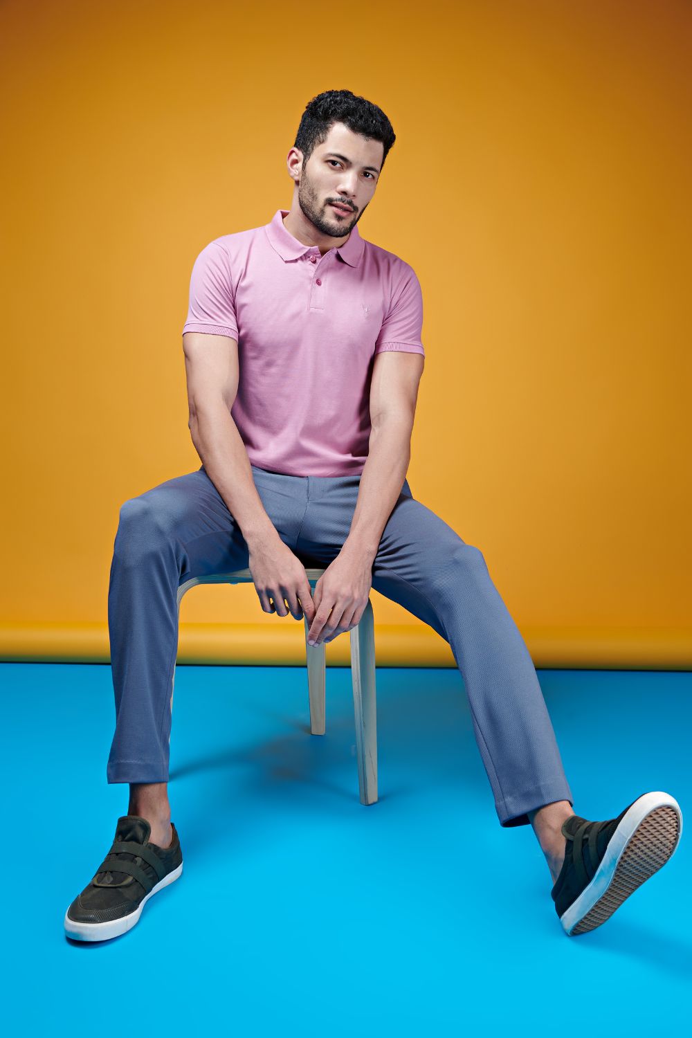 A model wearing Pink colored, Ramie edition Polo T-shirts for men with collar and half sleeves.