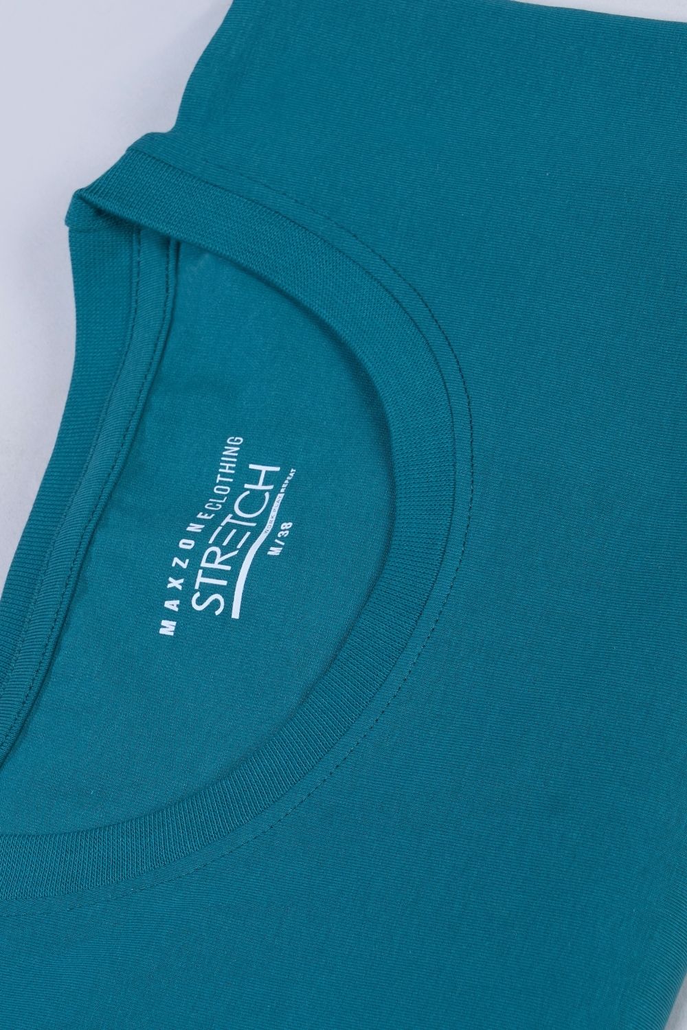 Cotton Stretch T shirt for men in the the solid color British Green with half sleeves and round neck, close up view.