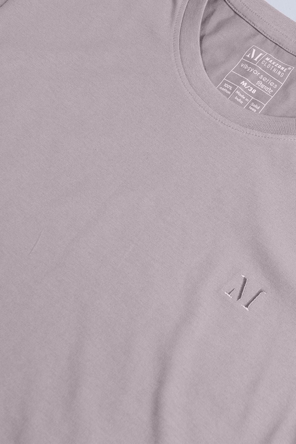 Coin grey colored, solid t shirt for men with round neck and half sleeves, closeup.