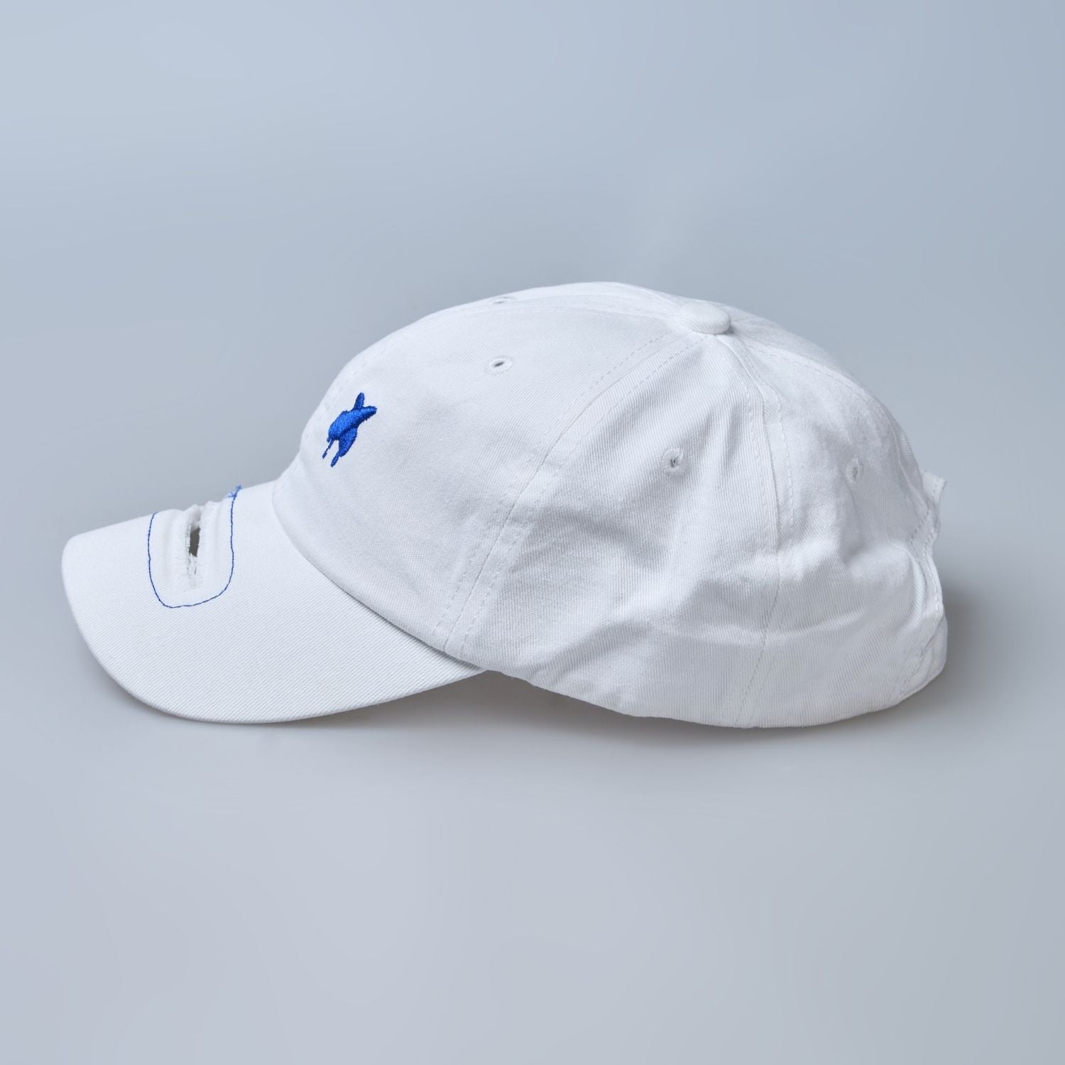 white colored, wide brim cap for men with adjustable strap, side view.