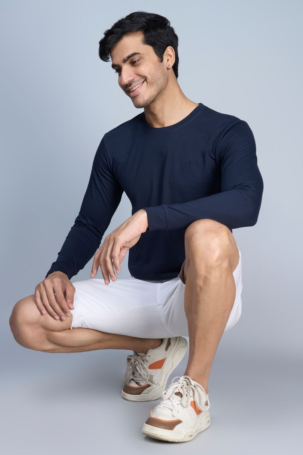 A model wearing Teal Navy colored, full sleeve solid T shirt for Men with round neck.