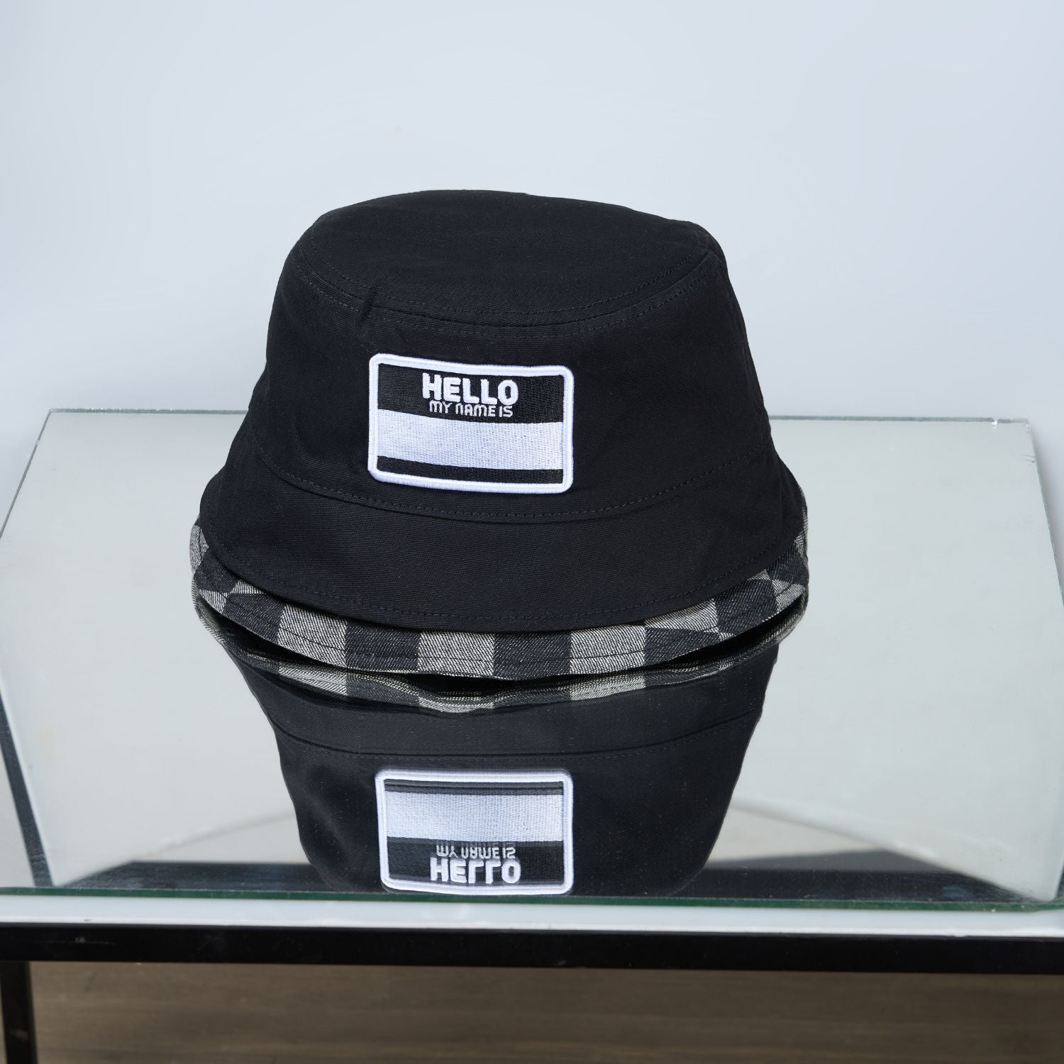 Black colored, chequered pattern, lightweight bucket hat for men, Front view.