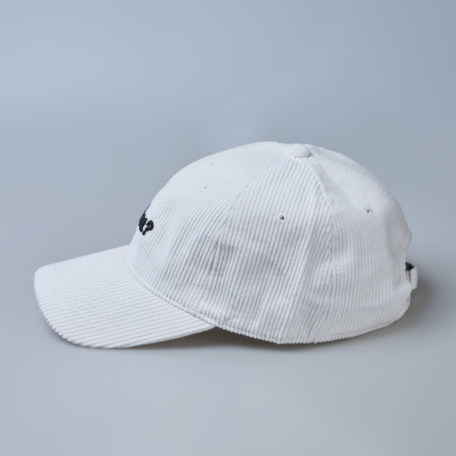 White colored cap for men with 'what' text written on it, side view.