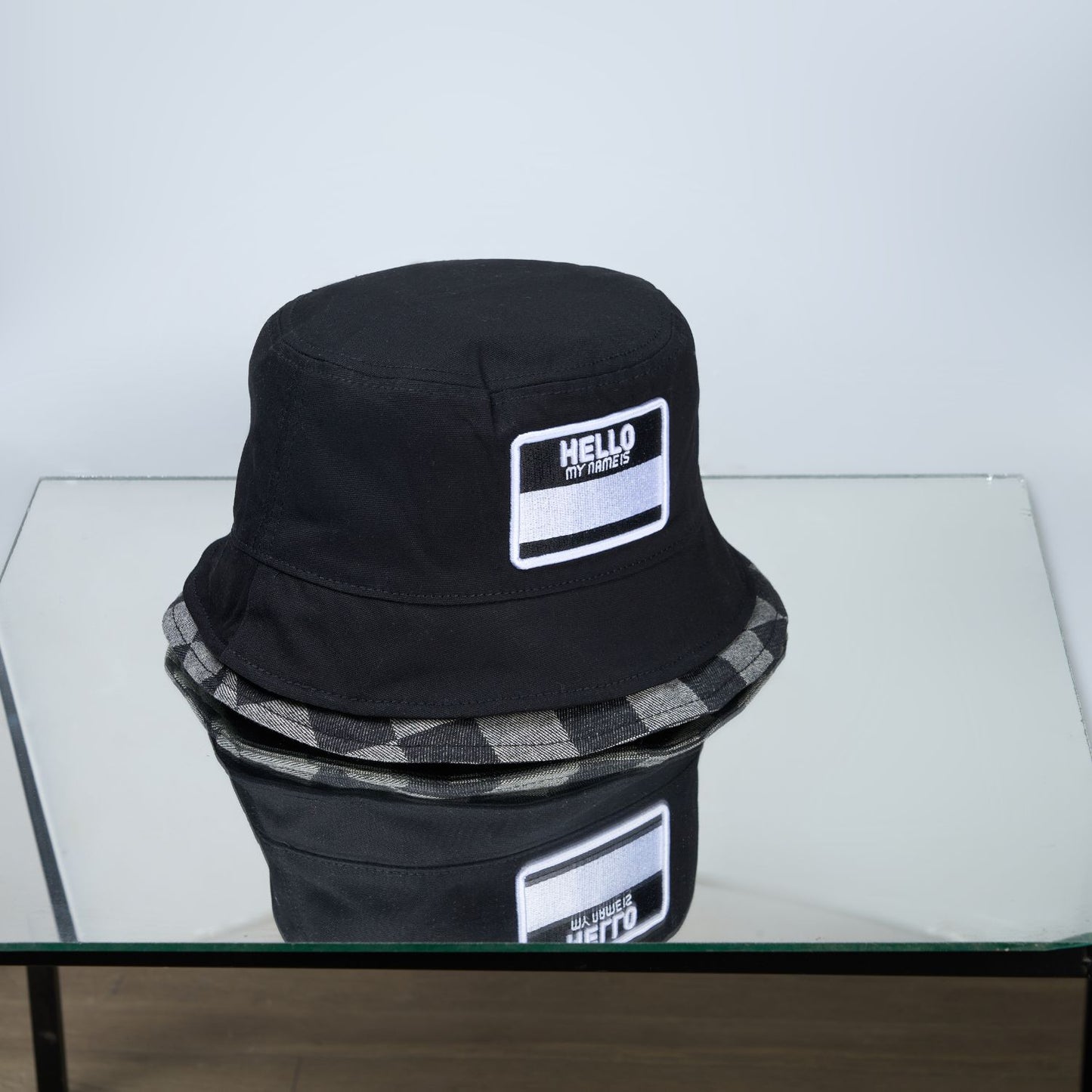 Black colored, chequered pattern, lightweight bucket hat for men, front design.