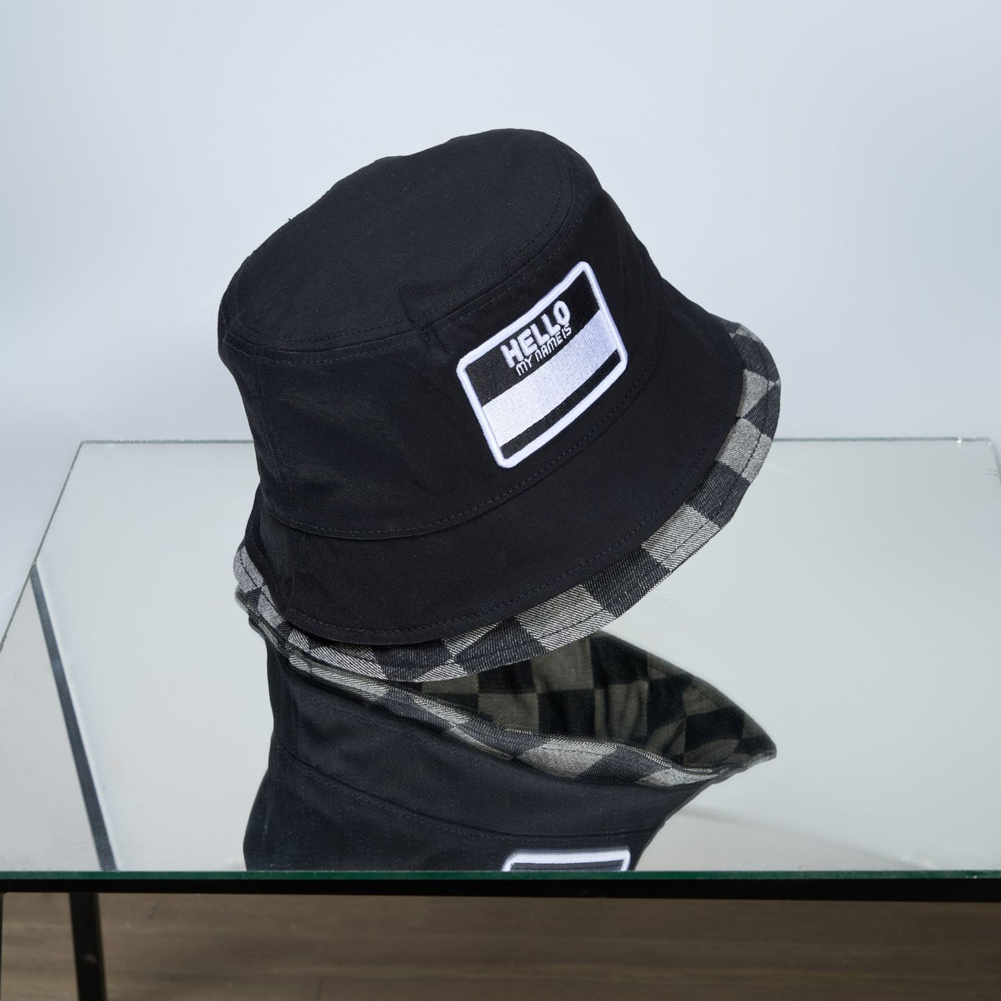 Black colored, chequered pattern, lightweight bucket hat for men, design detail.