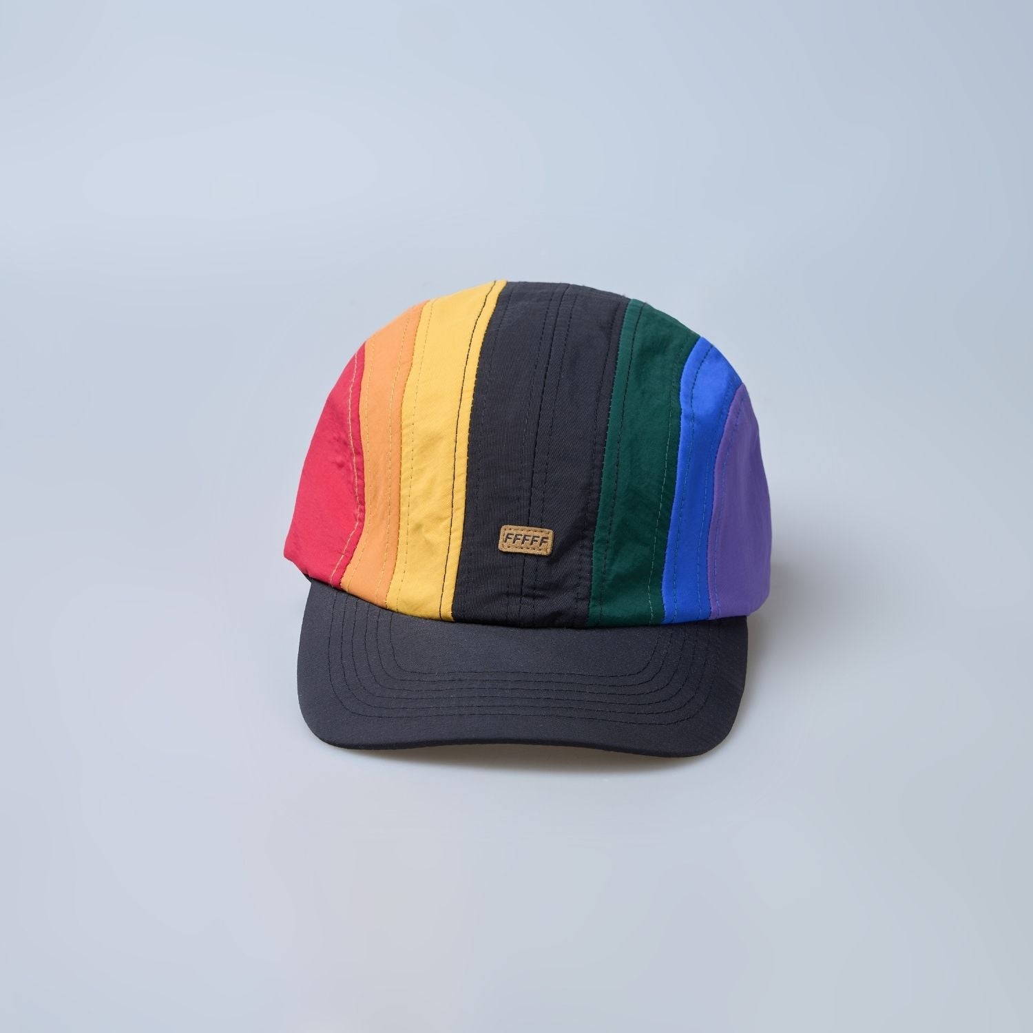Multi colored, wide brim cap for men with adjustable strap, front view.