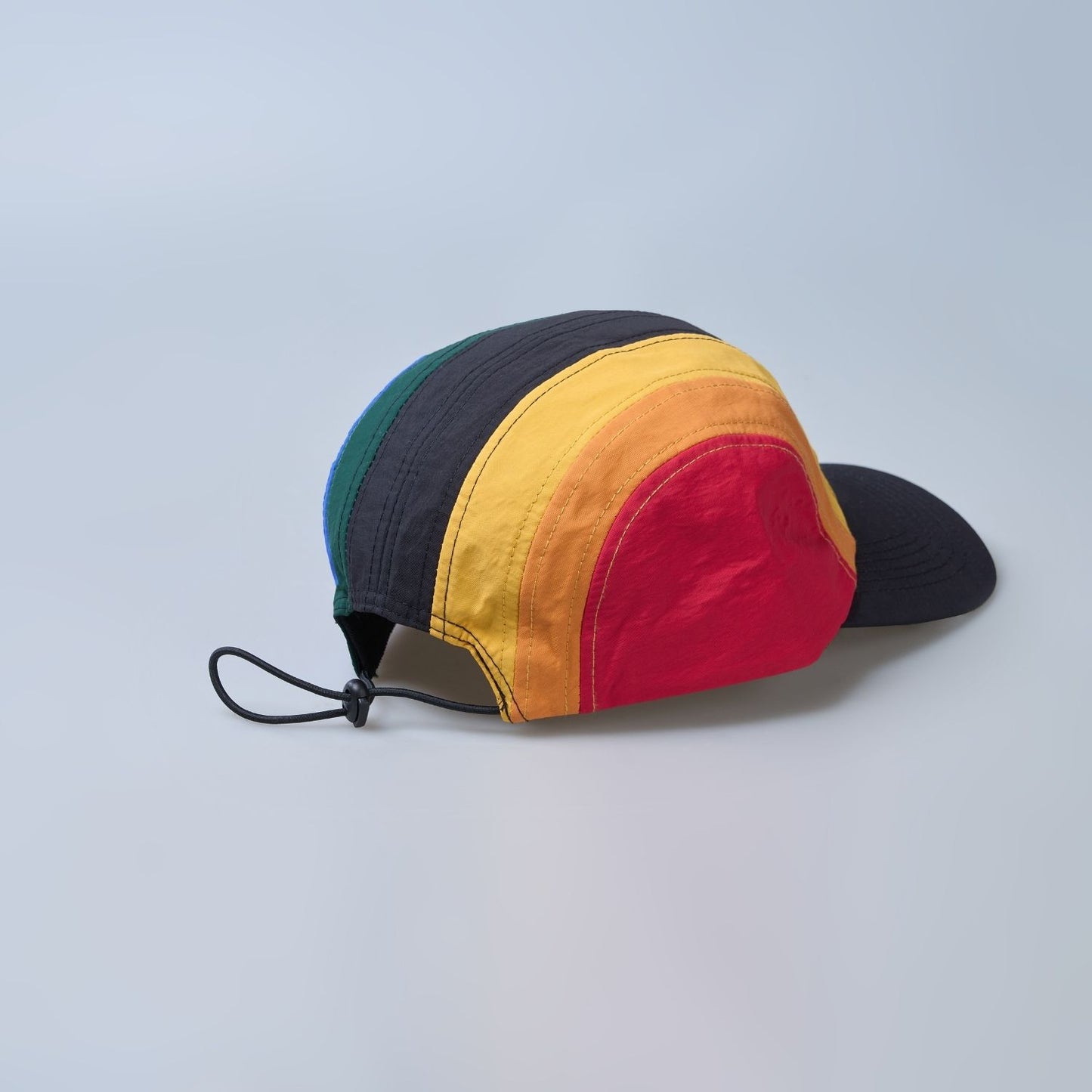 Multi colored, wide brim cap for men with adjustable strap, back view.