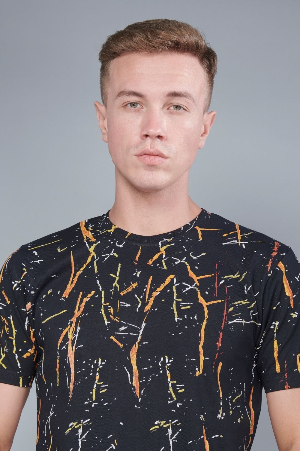 Black color, sprinkle patterned all over print T shirt for men with half sleeves and round neck, close up.