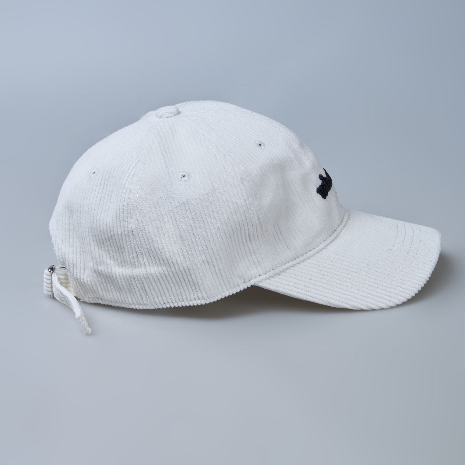 White colored cap for men with 'what' text written on it, side design detail.