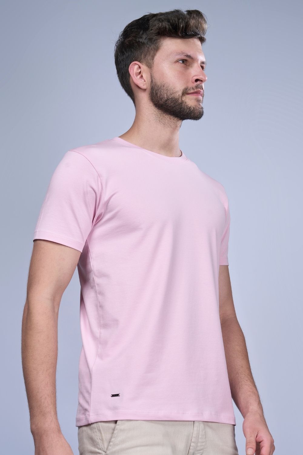 A model wearing Cotton Stretch T shirt for men in the solid color lilac shade with half sleeves and round neck.