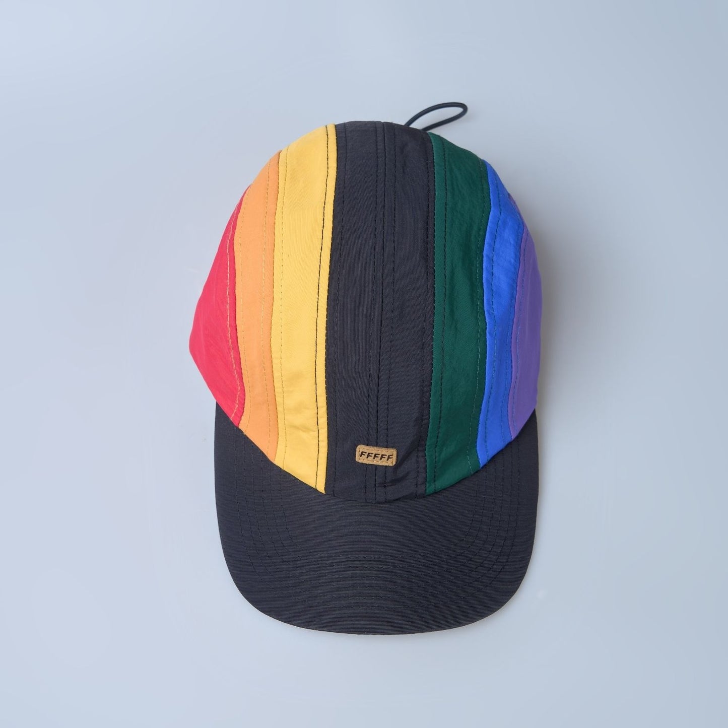 Multi colored, wide brim cap for men with adjustable strap, top view.