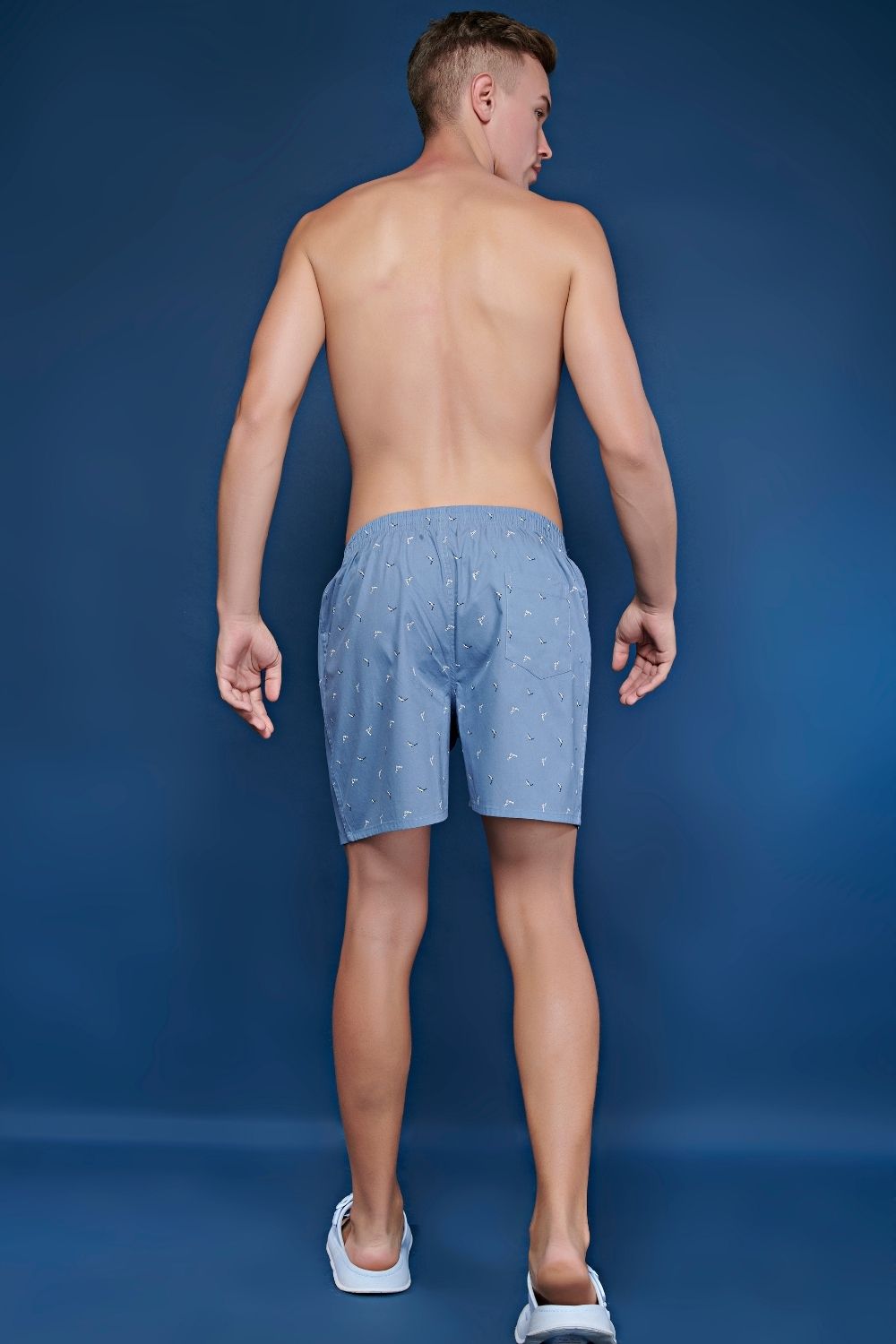 C. G. Blue colored all over printed cotton boxer for men with back pockets, back.