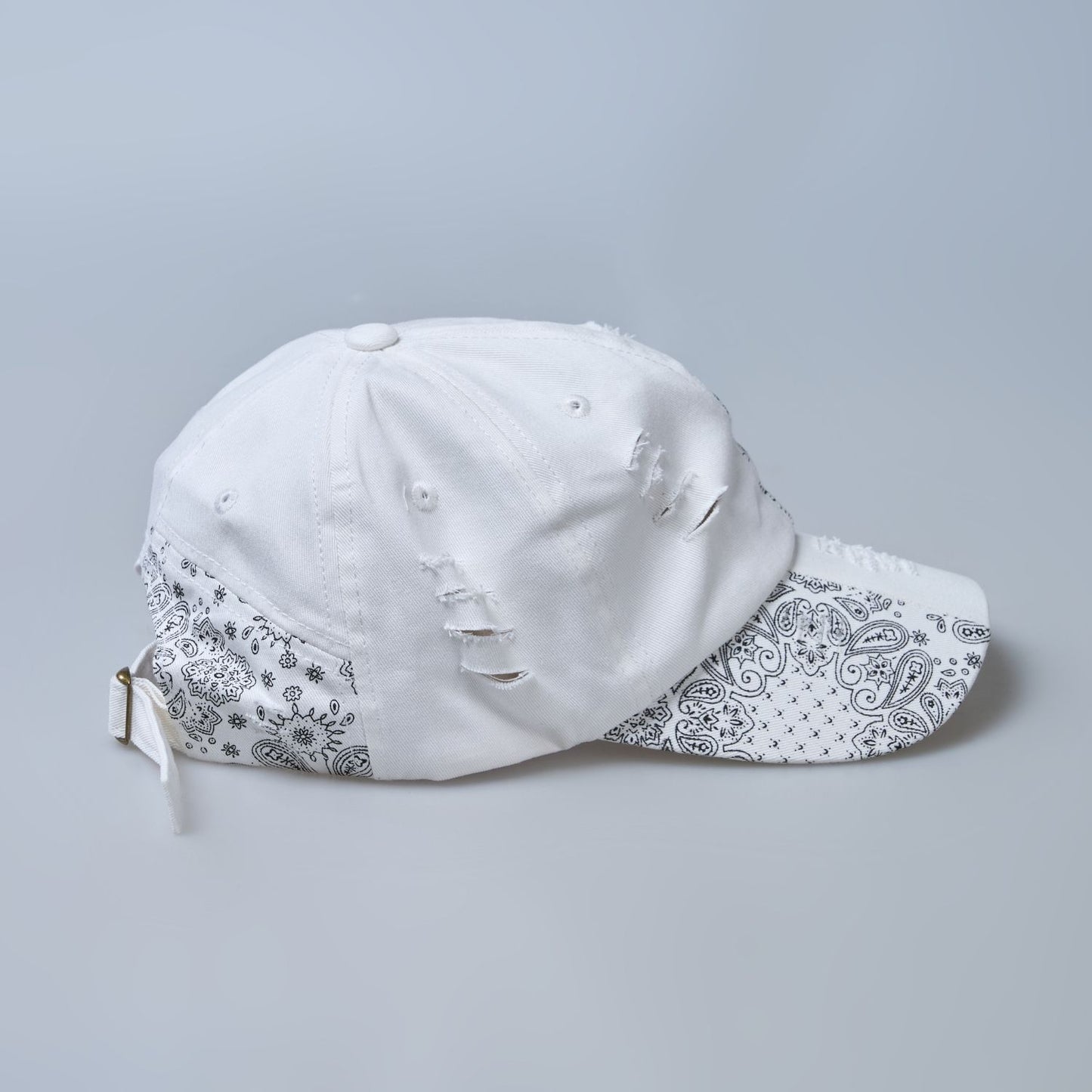 white colored, wide brim designer cap for men with adjustable strap, side view.