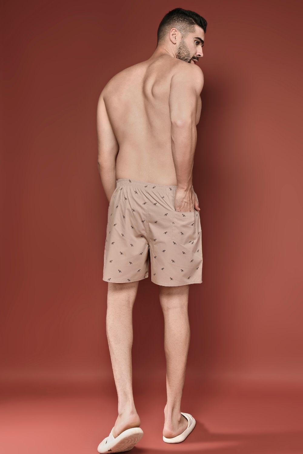 Apricot colored all over printed cotton boxer for men with back pockets, back.