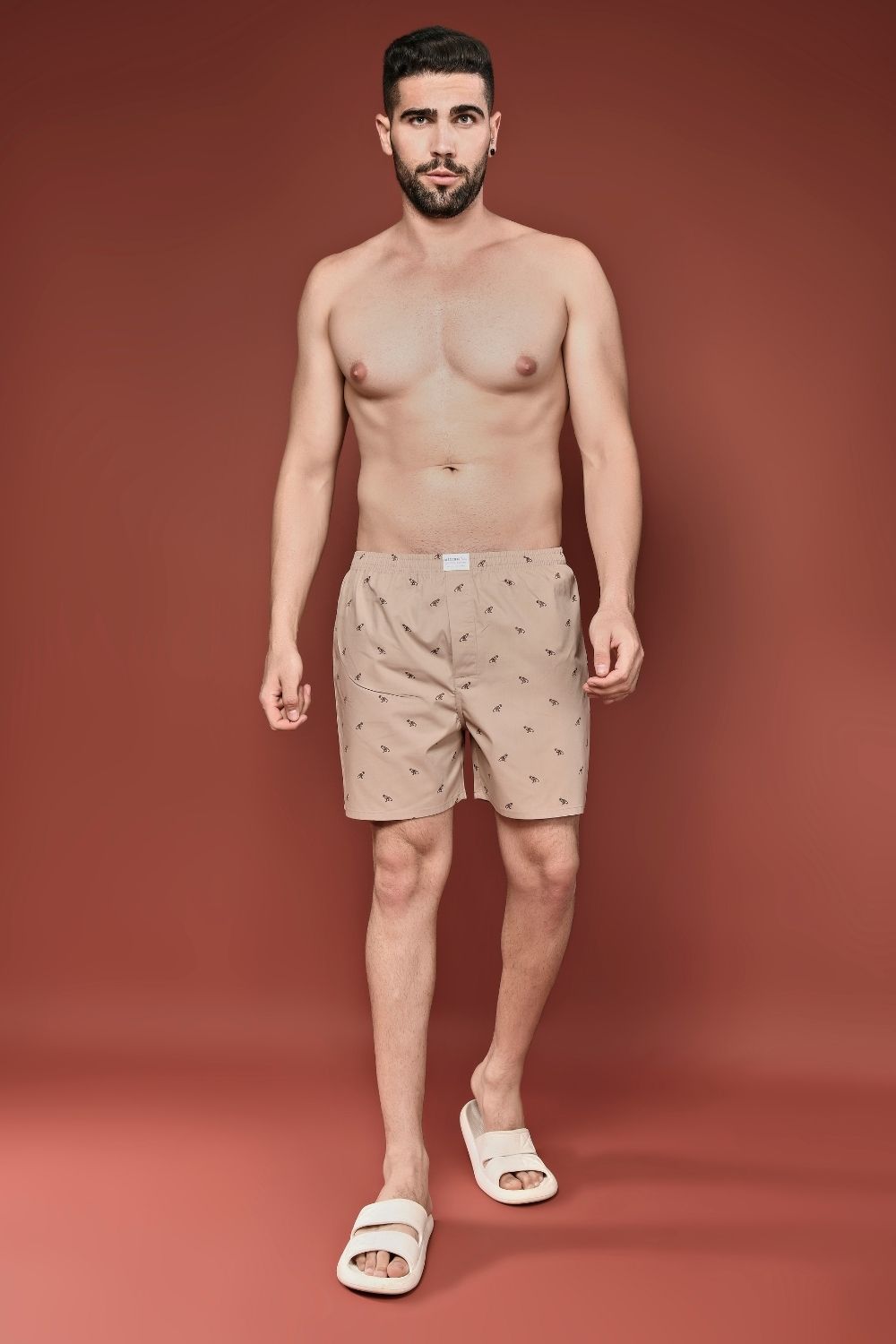 Apricot colored all over printed cotton boxer for men with back pockets, front.