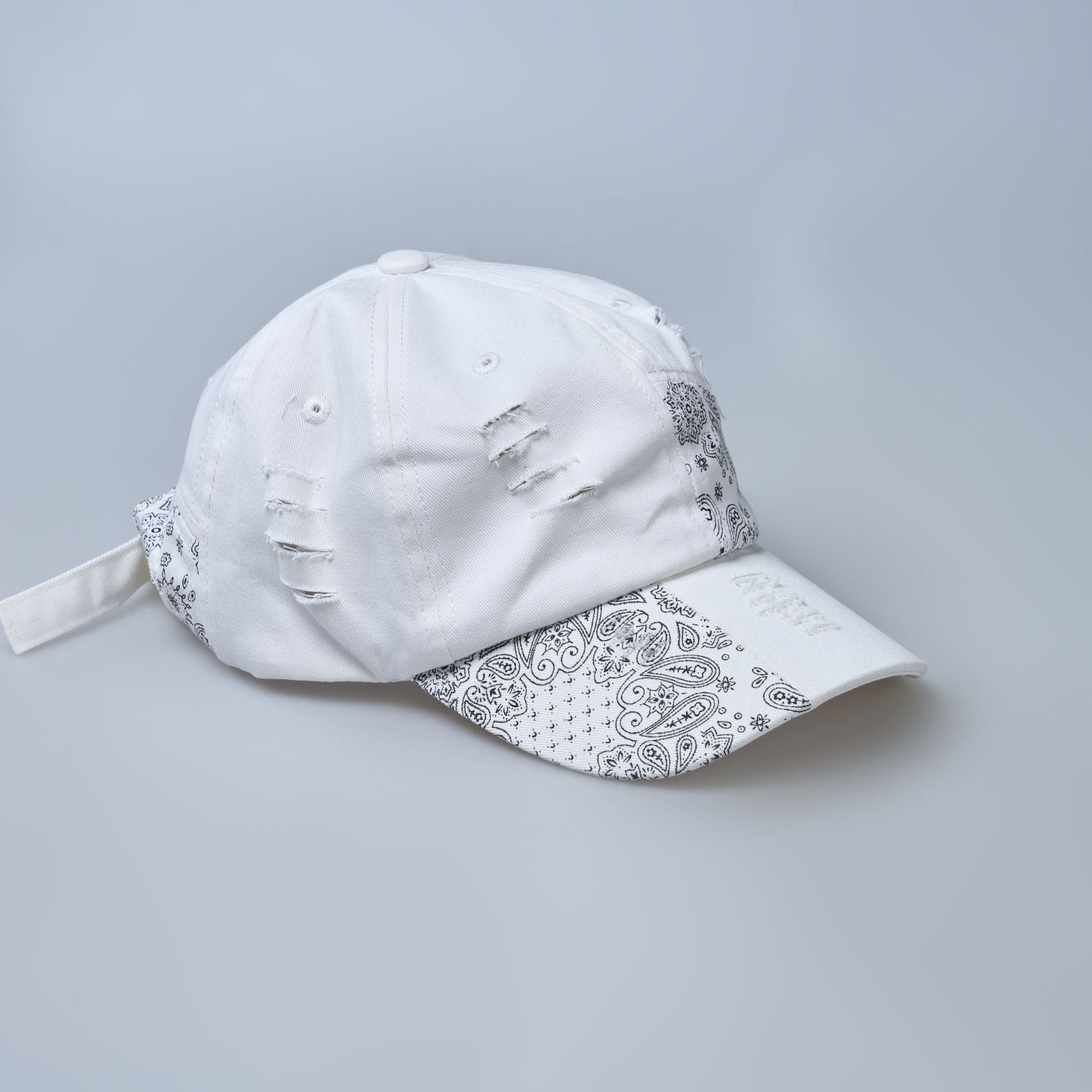 white colored, wide brim designer cap for men with adjustable strap, side design close up.