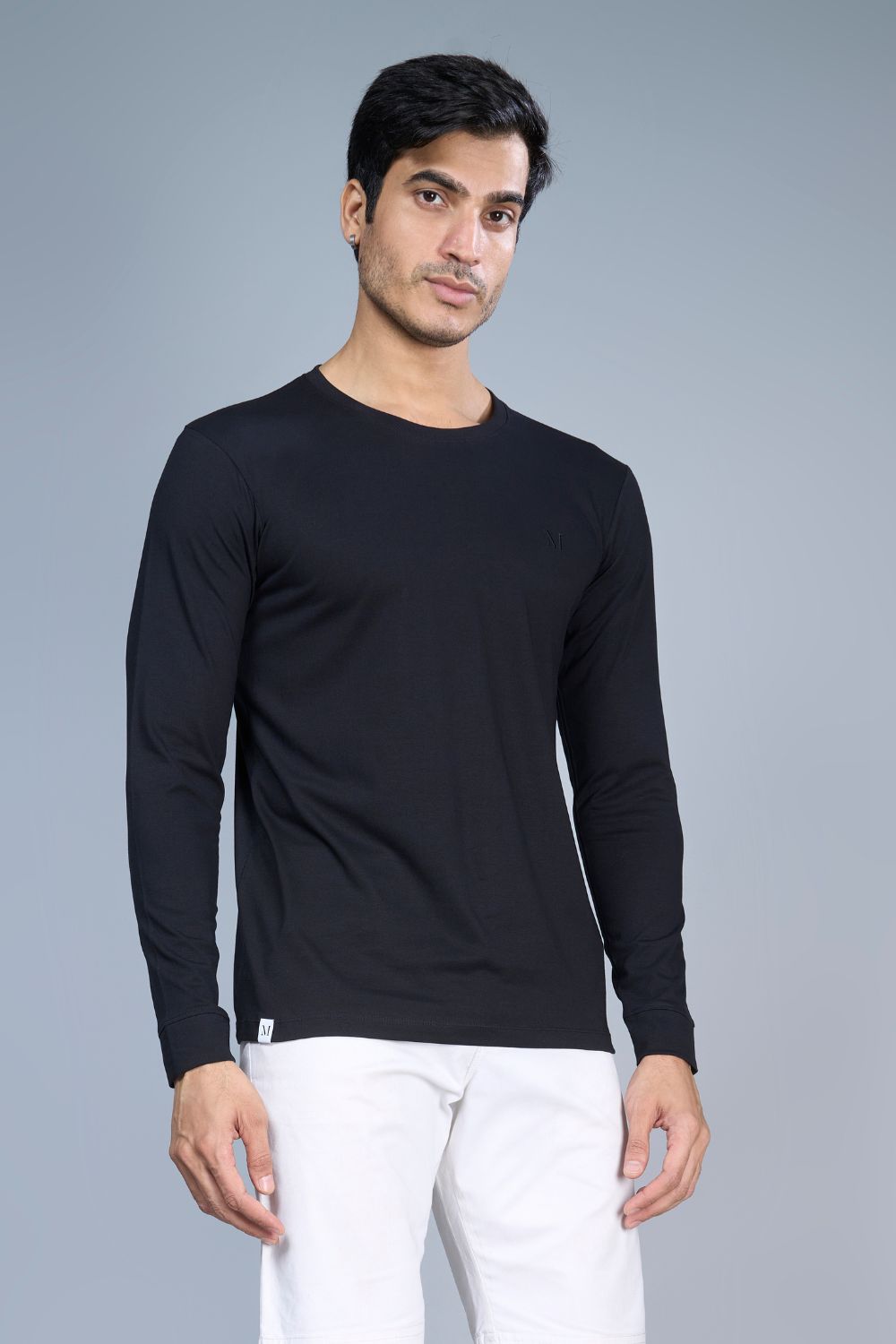 Black colored, full sleeve solid T shirt for Men with round neck, front view.