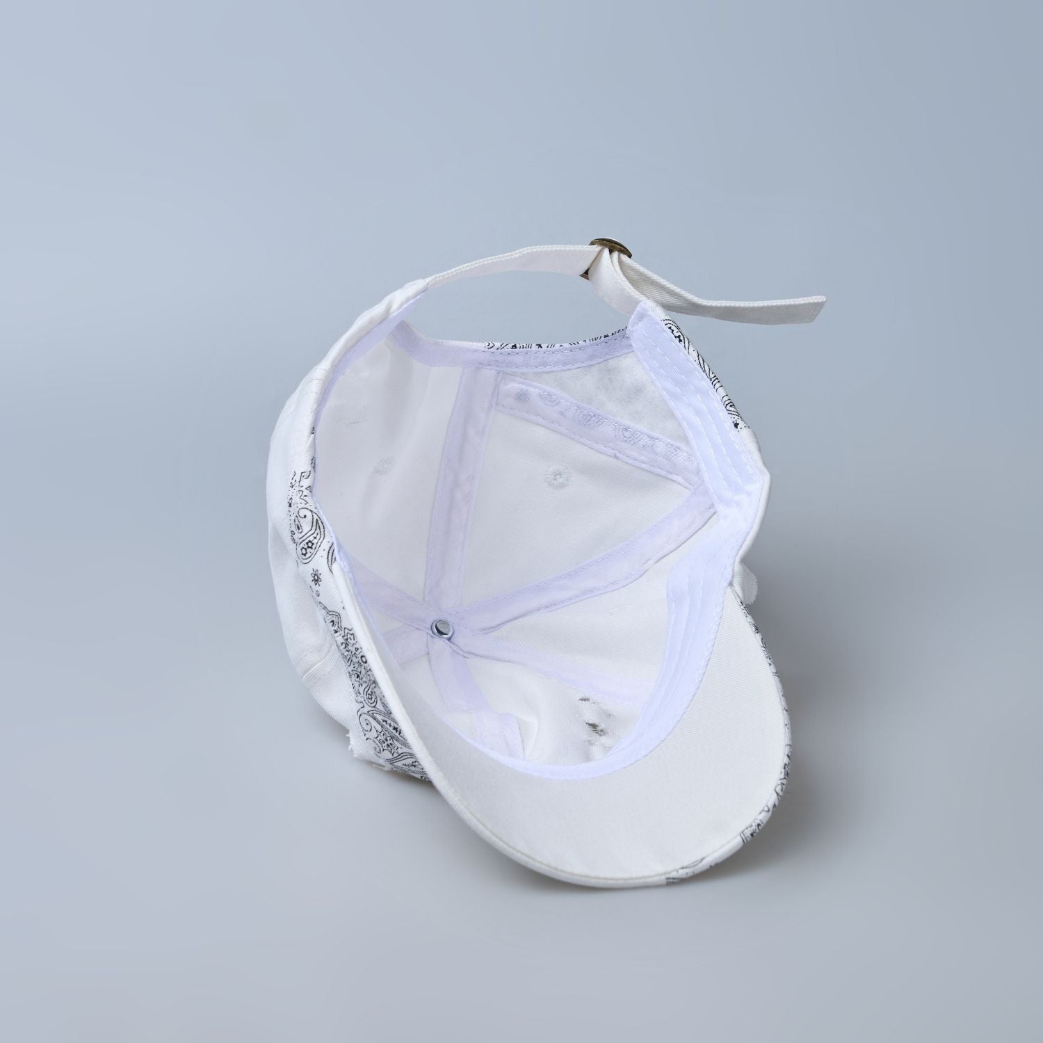 white colored, wide brim designer cap for men with adjustable strap, inside.