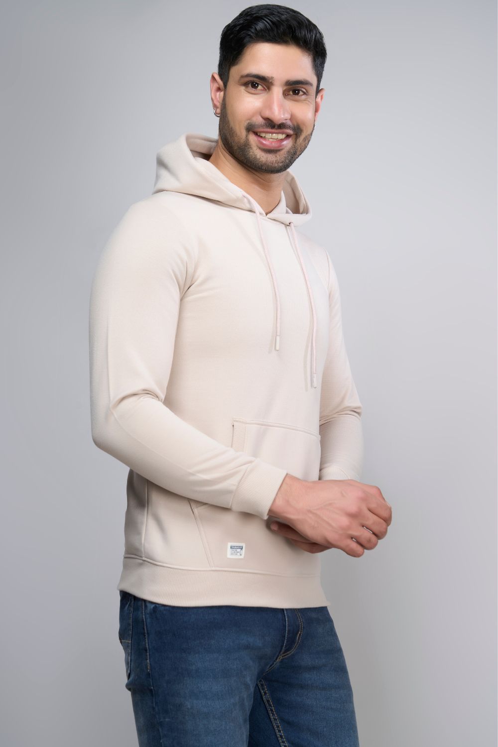 Soft Beige colored, hoodie for men with full sleeves and relaxed fit, side view.