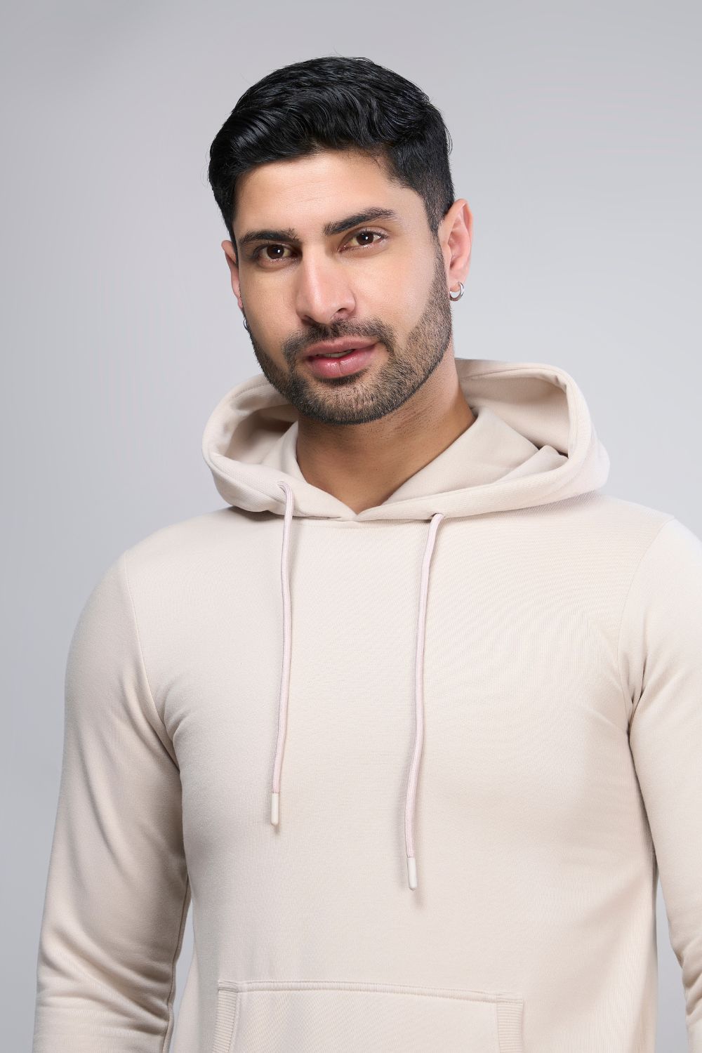 Soft Beige colored, hoodie for men with full sleeves and relaxed fit, close up.