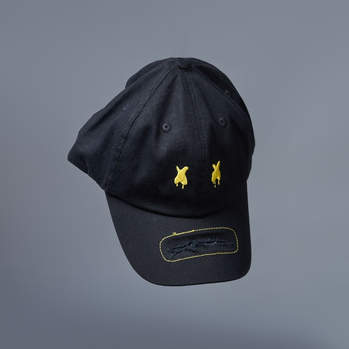 Detailed view of Black colored solid basic cap for men.