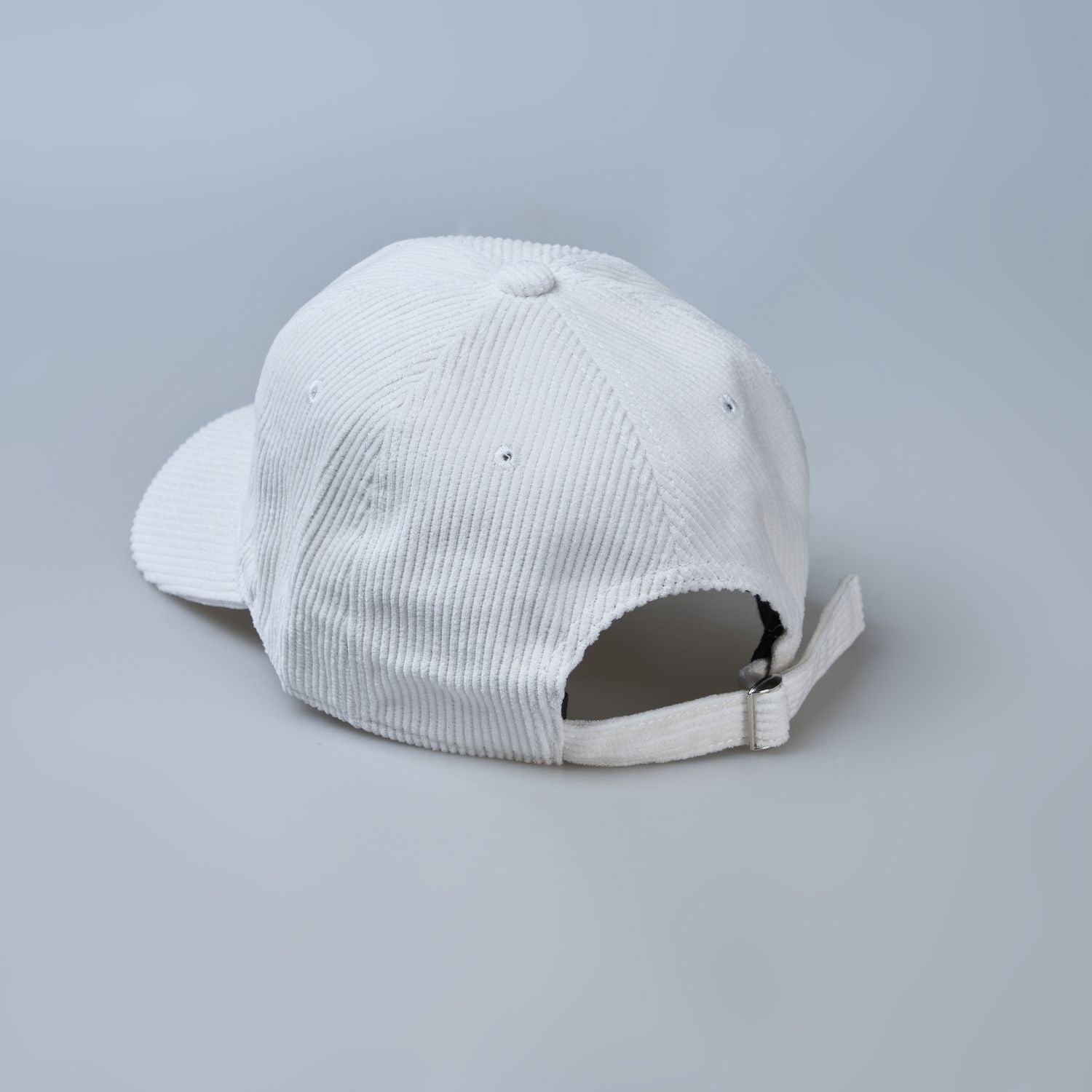 White colored cap for men with 'what' text written on it, back view.