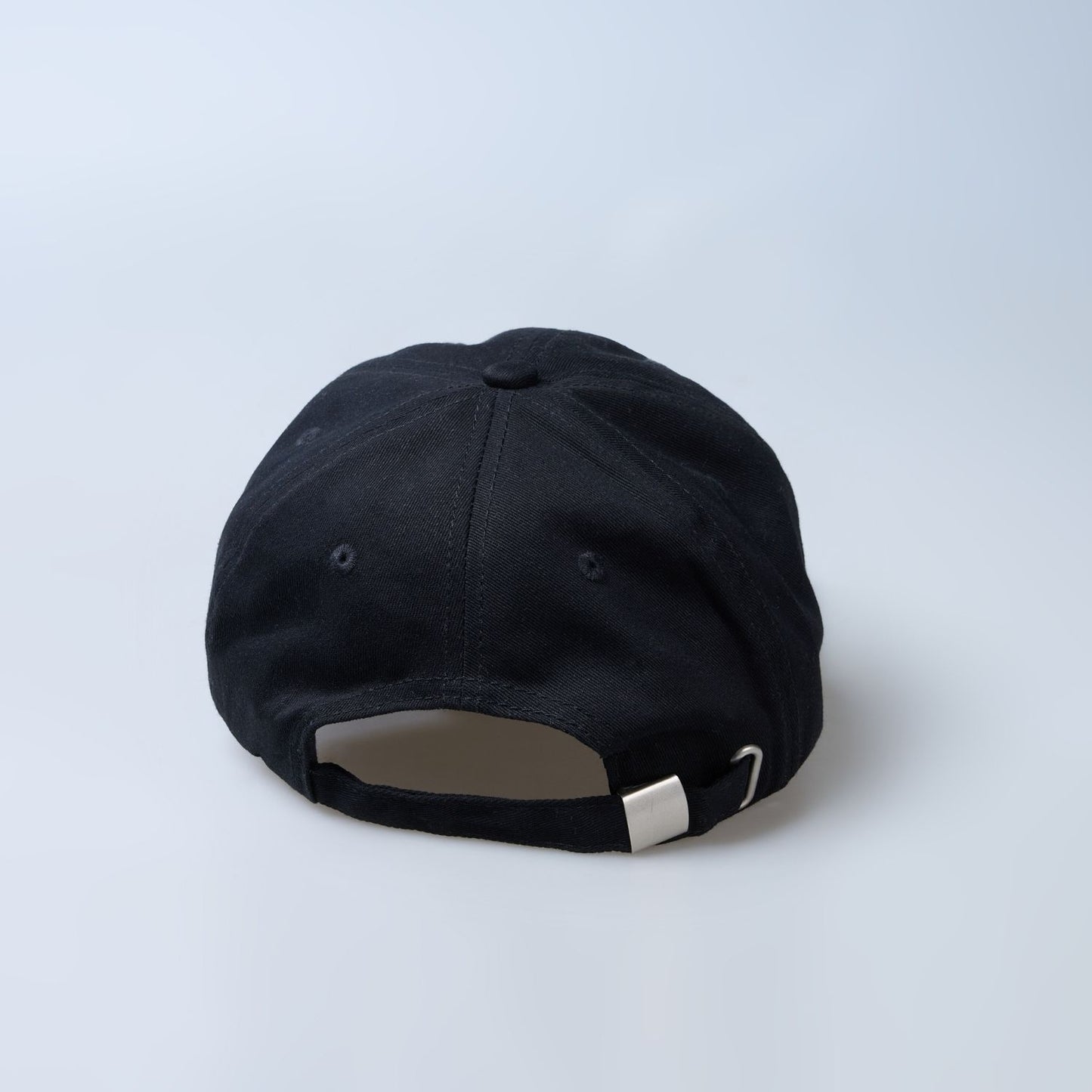 Back view of Black colored solid basic cap for men.