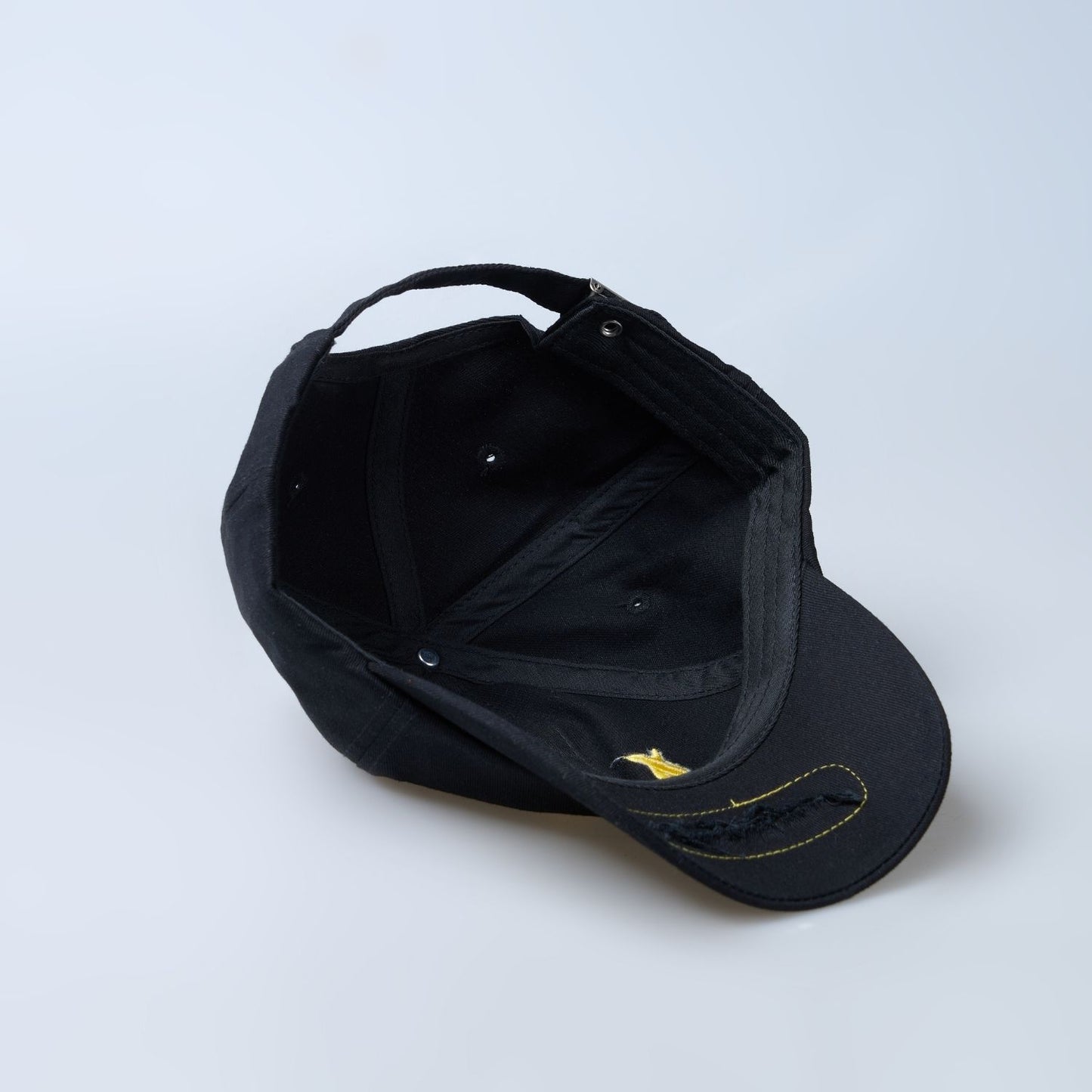 Black colored solid basic cap for men upside down.