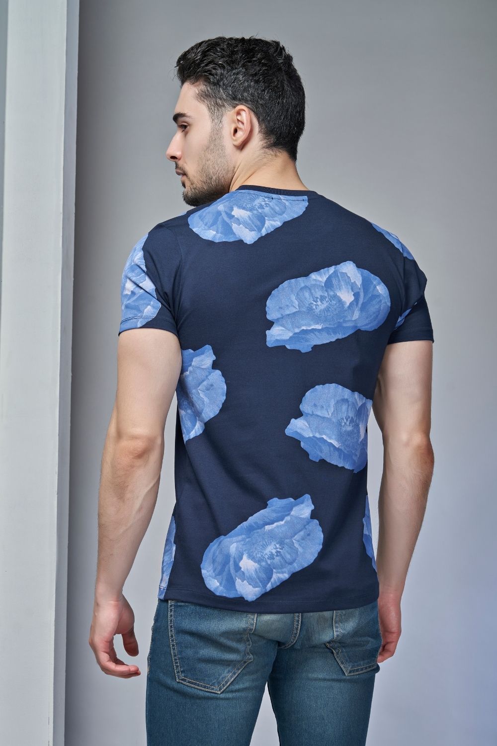 Back View of Royal Blue colored all over rose print T shirt for men with half sleeves and round neck.
