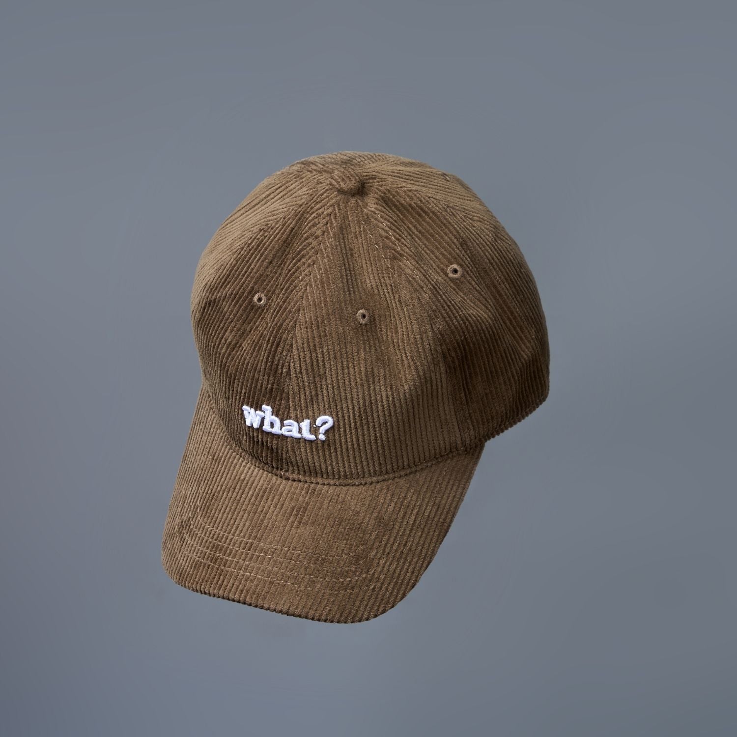 Brown colored cap for men with 'what' text written on it, design detail.