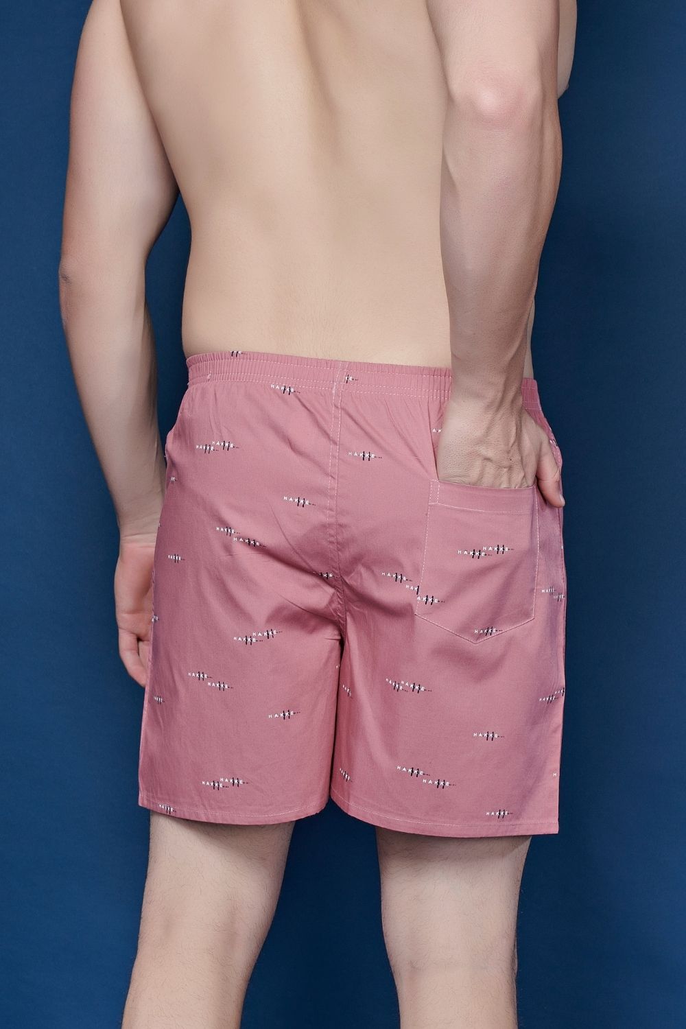 Pink colored all over printed cotton boxer for men with back pockets close up.
