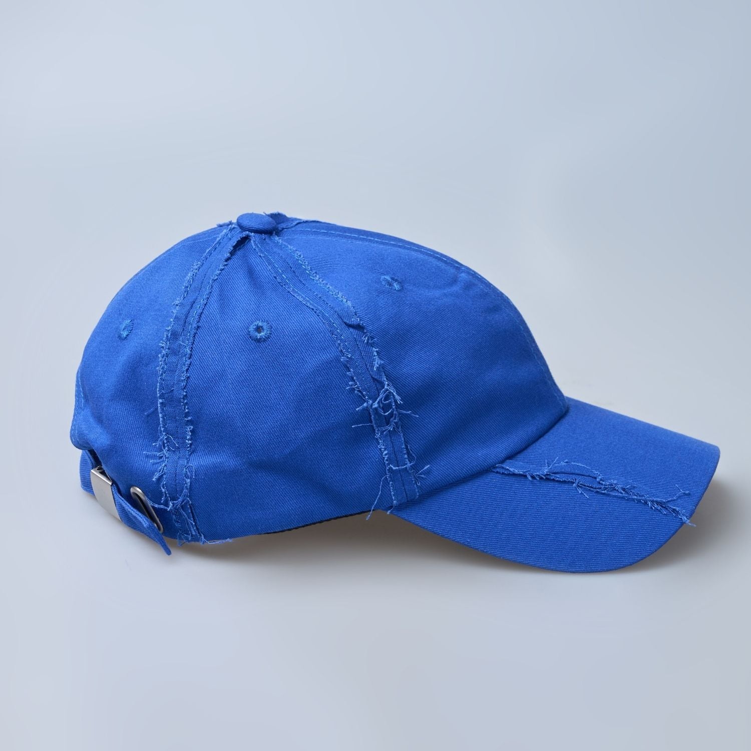 Blue colored, wide brim cap for men with adjustable strap, side view.