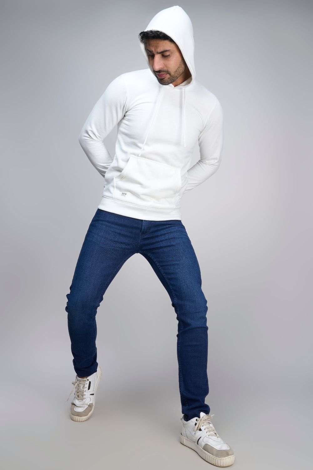 A model wearing White colored, hoodie for men with full sleeves and relaxed fit.