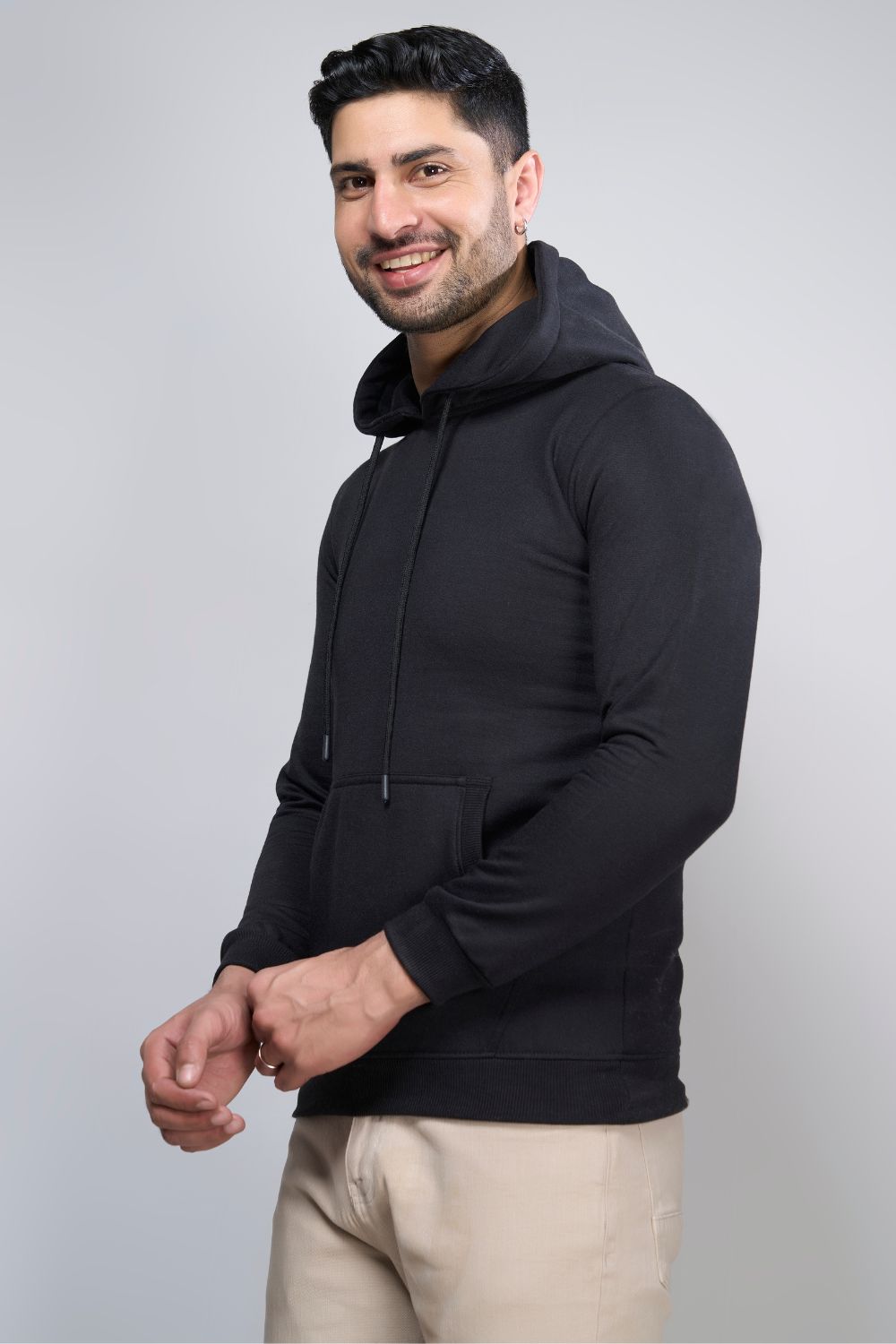 Black colored, hoodie for men with full sleeves and relaxed fit, side view