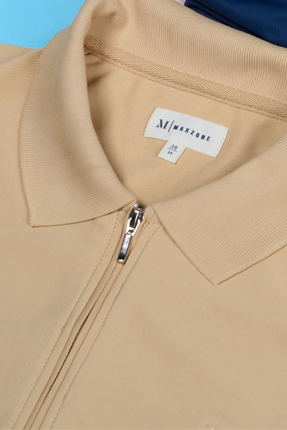 Bisque colored, zipped Polo T-shirts for men with collar and half sleeves, product close up.